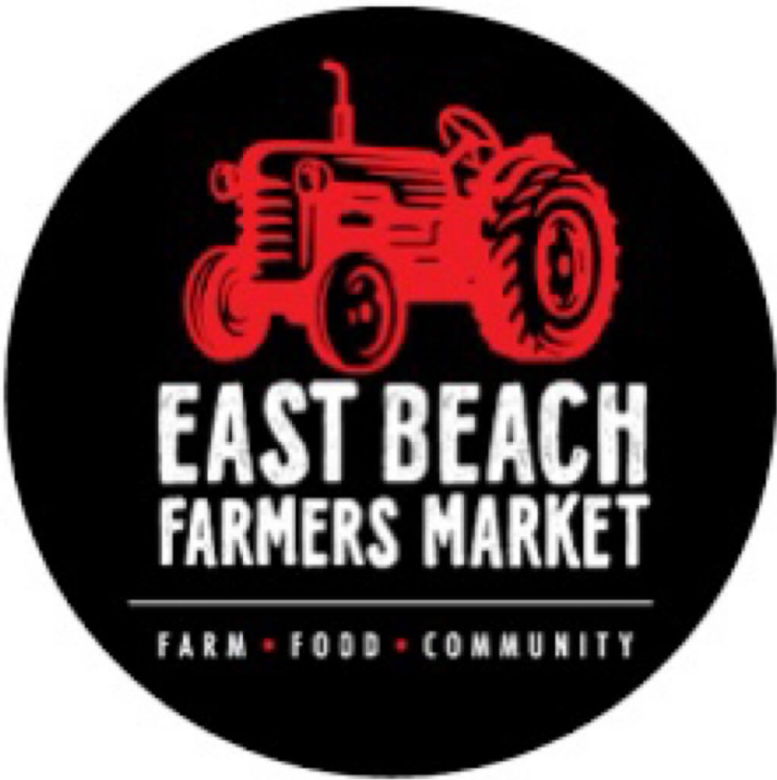East Beach Farmers Market circular logo featuring a red tractor, bold white text, and Farm Food Community tagline on black.