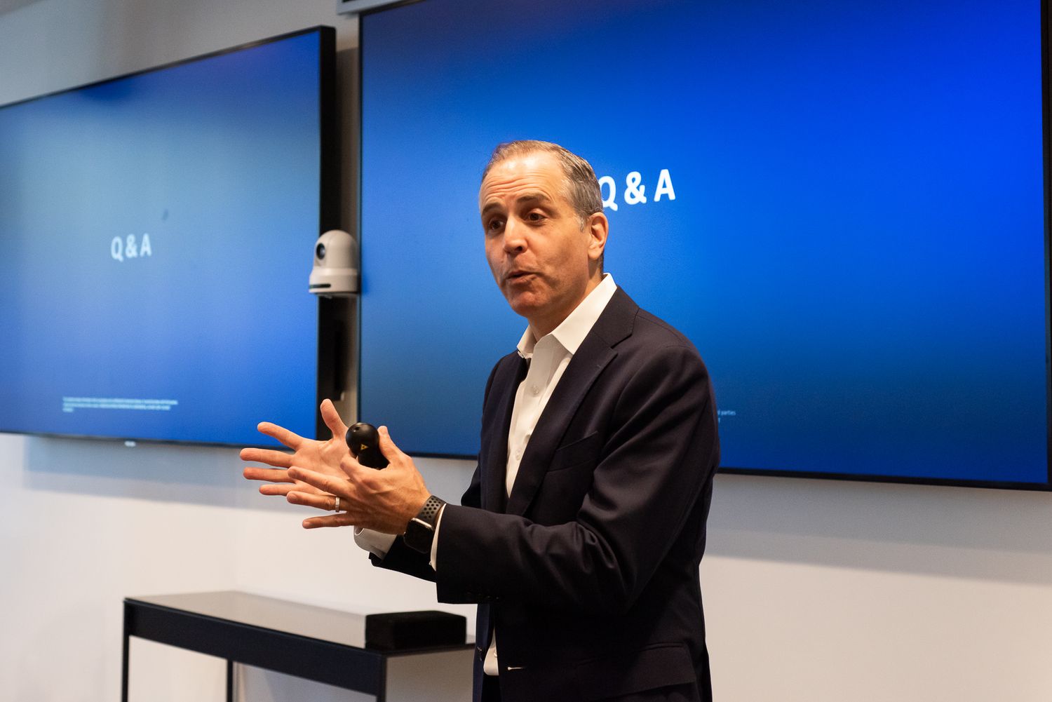 Professional presentation setup with bright blue digital displays in a modern conference room.