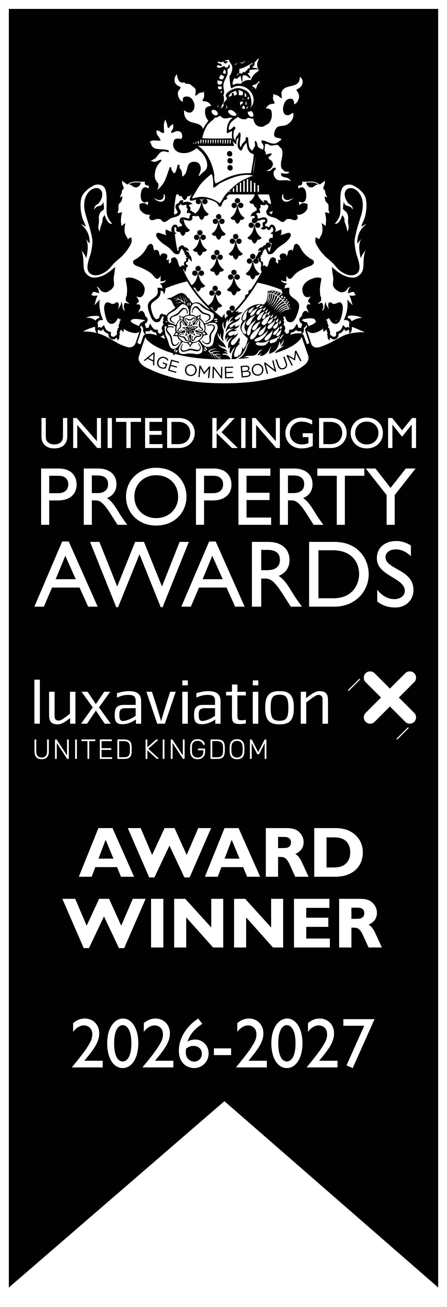 United Kingdom Property Awards 2026-2027 Award Winner banner with Luxaviation UK logo and heraldic crest on black background.
