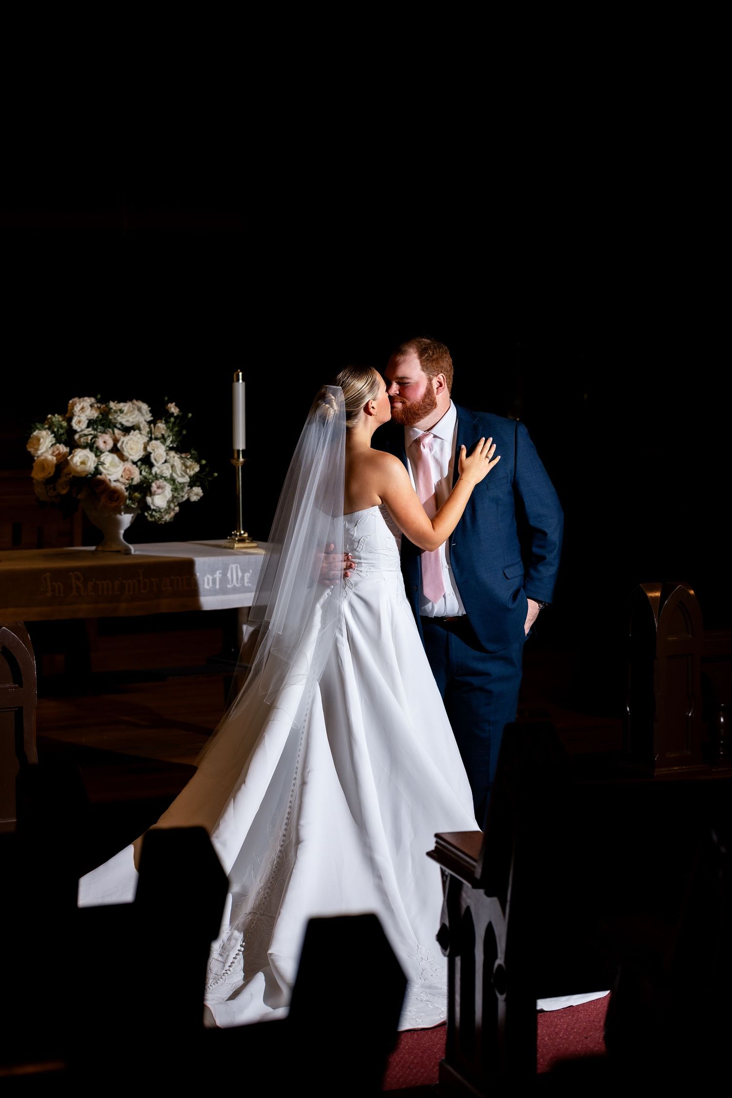 Wedding portrait of young Cincinnati Couple kissing at the alter