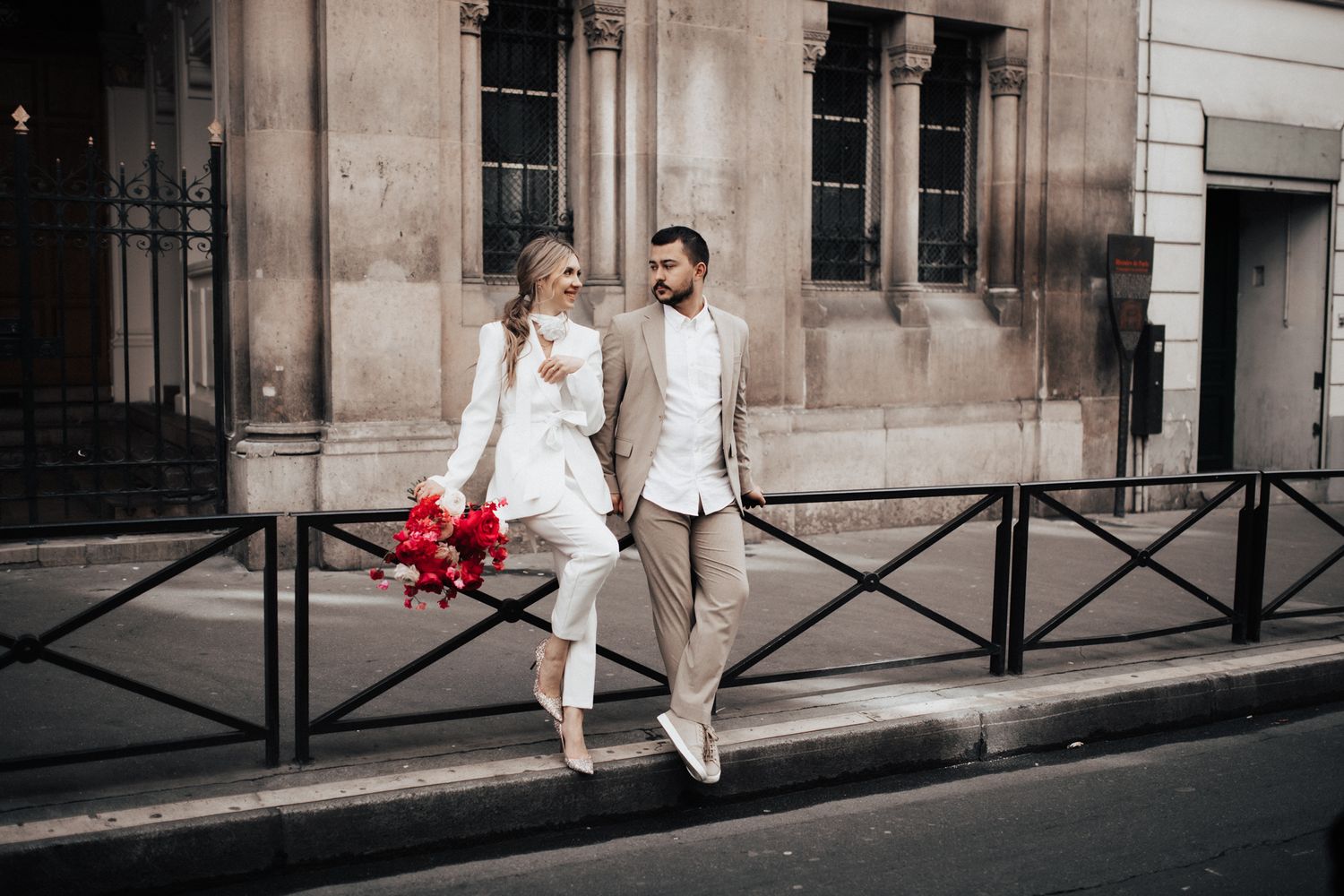 Young Cincinnati couple chatting on a rail after bridal portraits