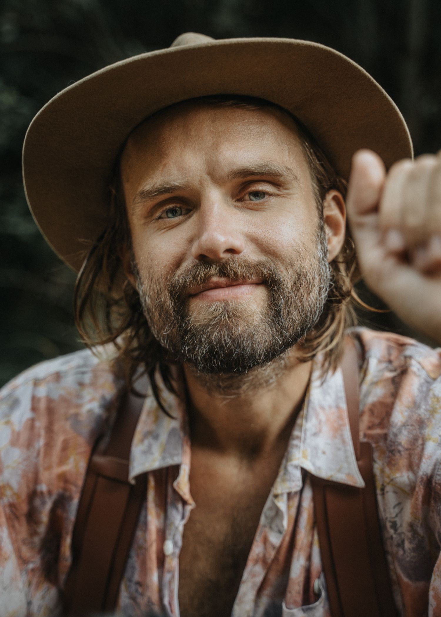 Natural portrait of a bearded man wearing a hat outdoors