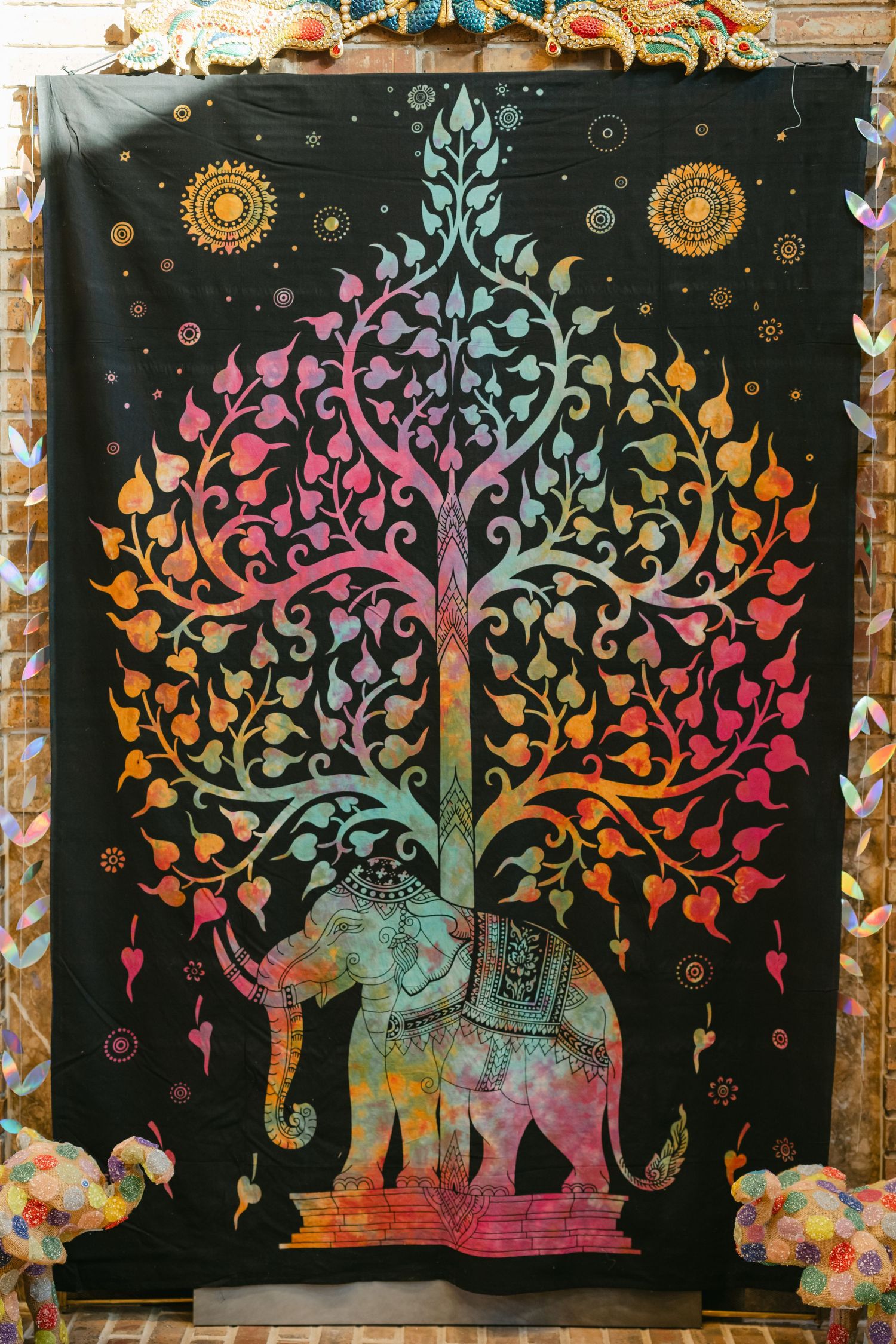 The Brix on the Fox Wedding - Colorful bohemian tapestry featuring elephants and trees in vibrant tie-dye patterns.
