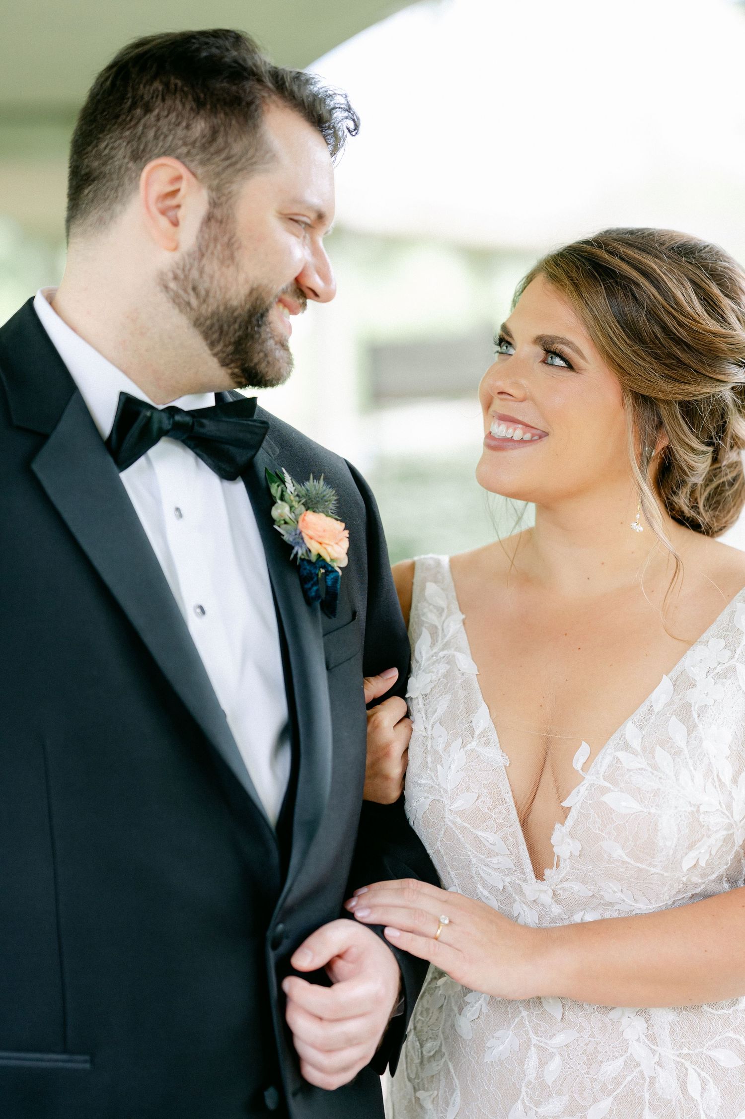 A joyful wedding moment captured between newlyweds in formal attire sharing a loving glance. - Hyatt Lodge Oak Brook Wedding