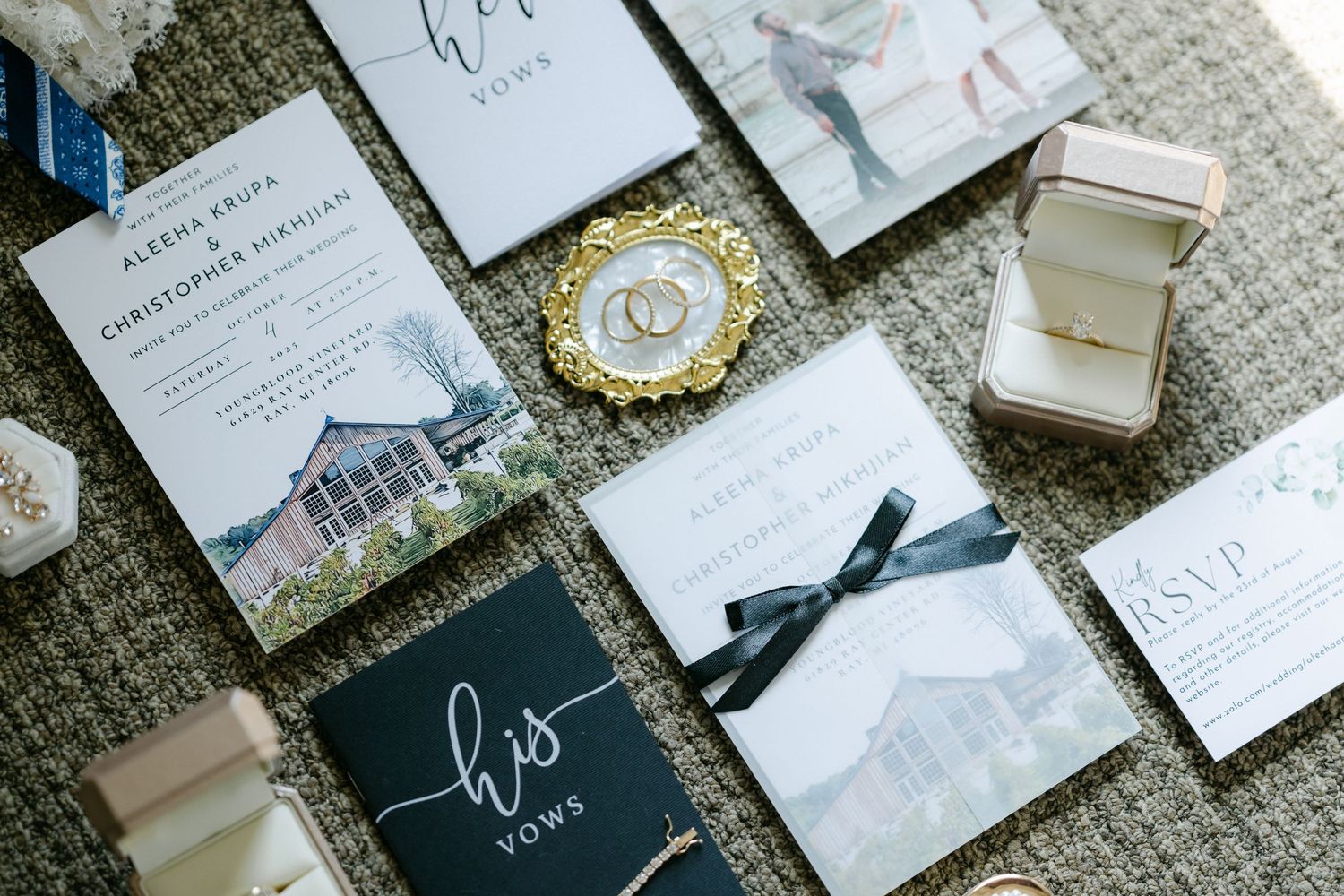Elegant wedding stationery flat lay featuring vow books, invitations, RSVP cards. - Youngblood Vineyard Wedding