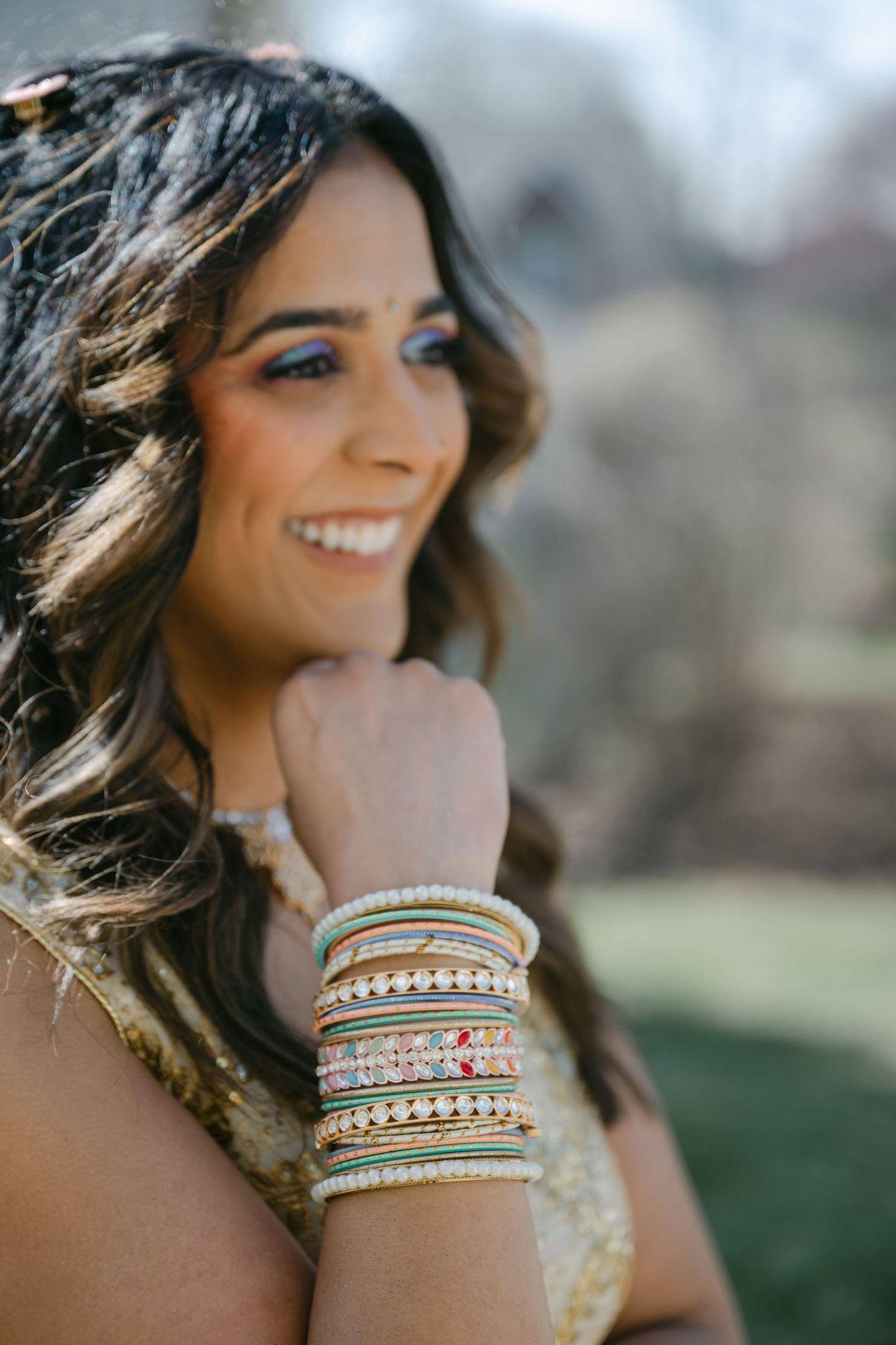 The Brix on the Fox Wedding - Close up portrait of someone wearing colorful stacked bangles and bracelets on their wrist.