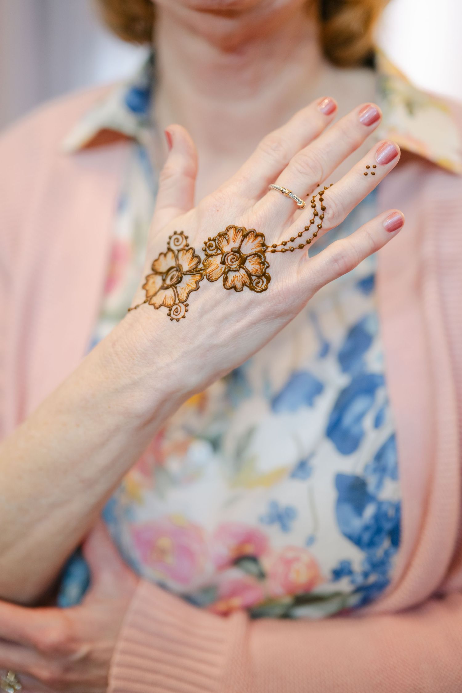 The Brix on the Fox Wedding -  Close-up shots of hands wearing ornate gold floral ring designs.