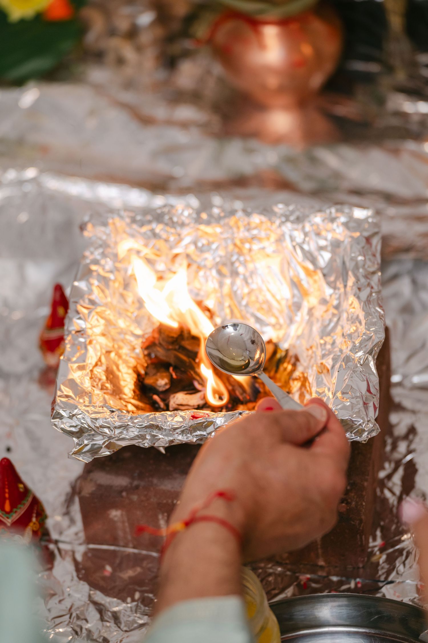 The Brix on the Fox Wedding - A sequence of photos showing aluminum foil being lit on fire and burning with bright orange flames.