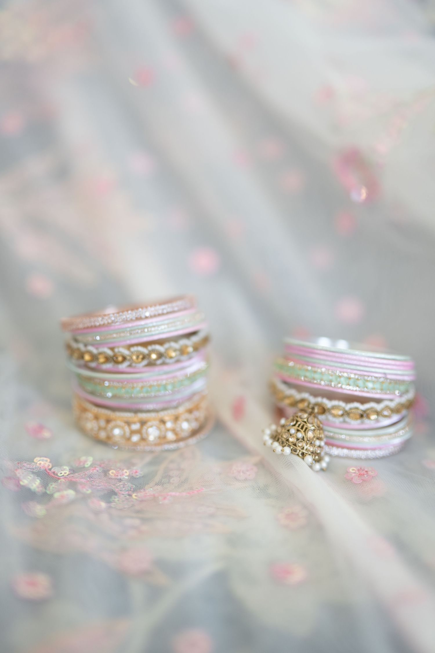 TThe Brix on the Fox Wedding - Delicate stacked rose gold and silver rings with diamond accents sparkle.