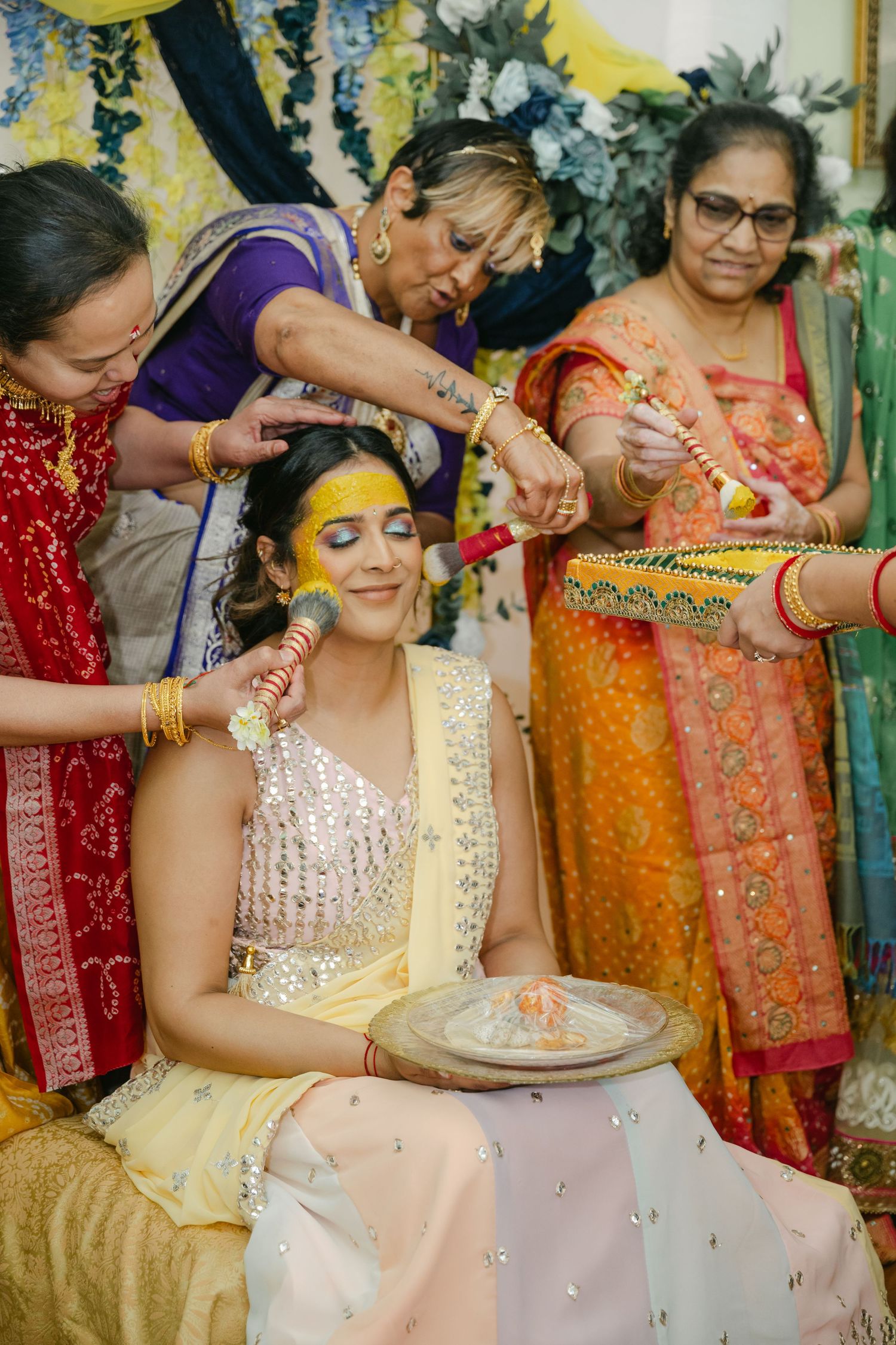 The Brix on the Fox Wedding -  Indian wedding ceremony preparations showing application of turmeric paste during Haldi ritual ceremony.