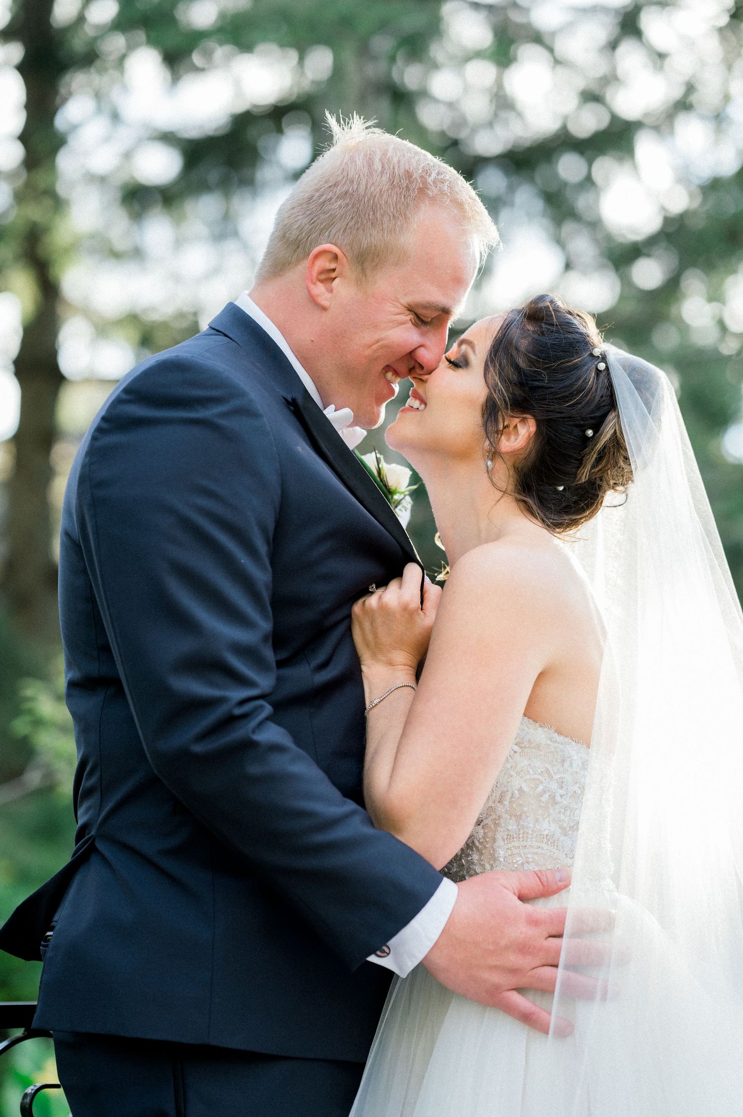 A romantic wedding couple shares tender kisses in a series of three outdoor photos with trees in the background. - Lombard, IL