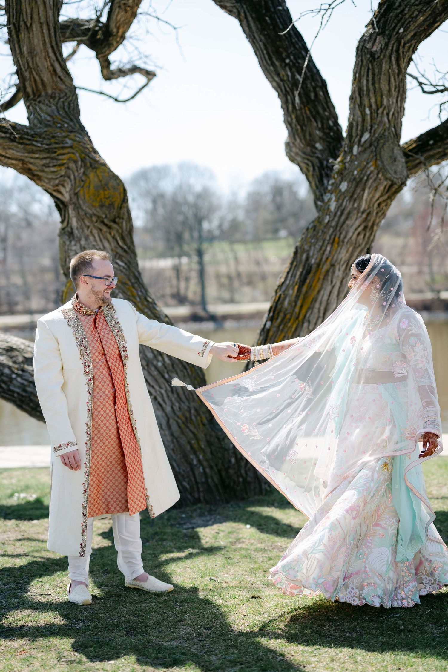Children play together under a large tree in the sunlight, one wearing white and the other in a patterned top. - The Brix on the Fox