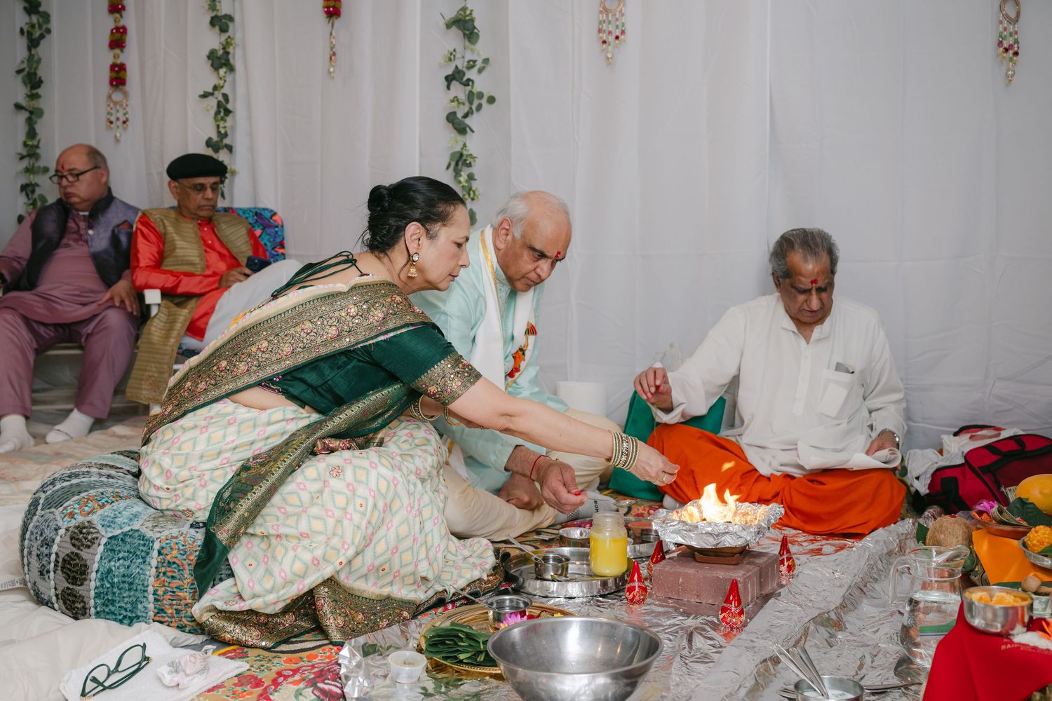 The Brix on the Fox Wedding -  People participate in a traditional Hindu prayer ceremony with offerings and rituals.