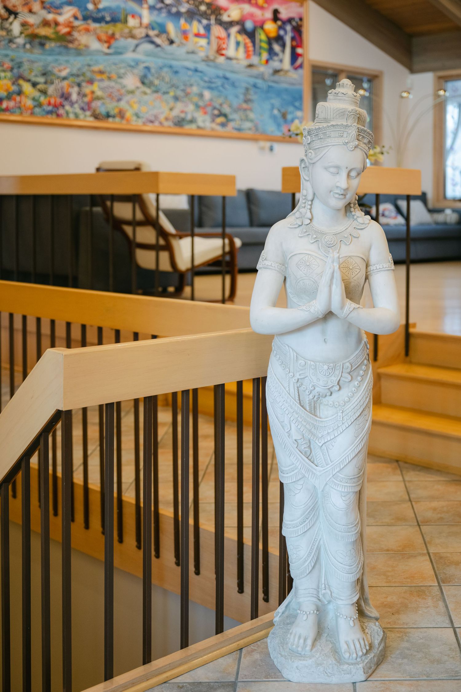 The Brix on the Fox Wedding - White decorative statue figures stand in a restaurant dining area with wooden tables and black railings.