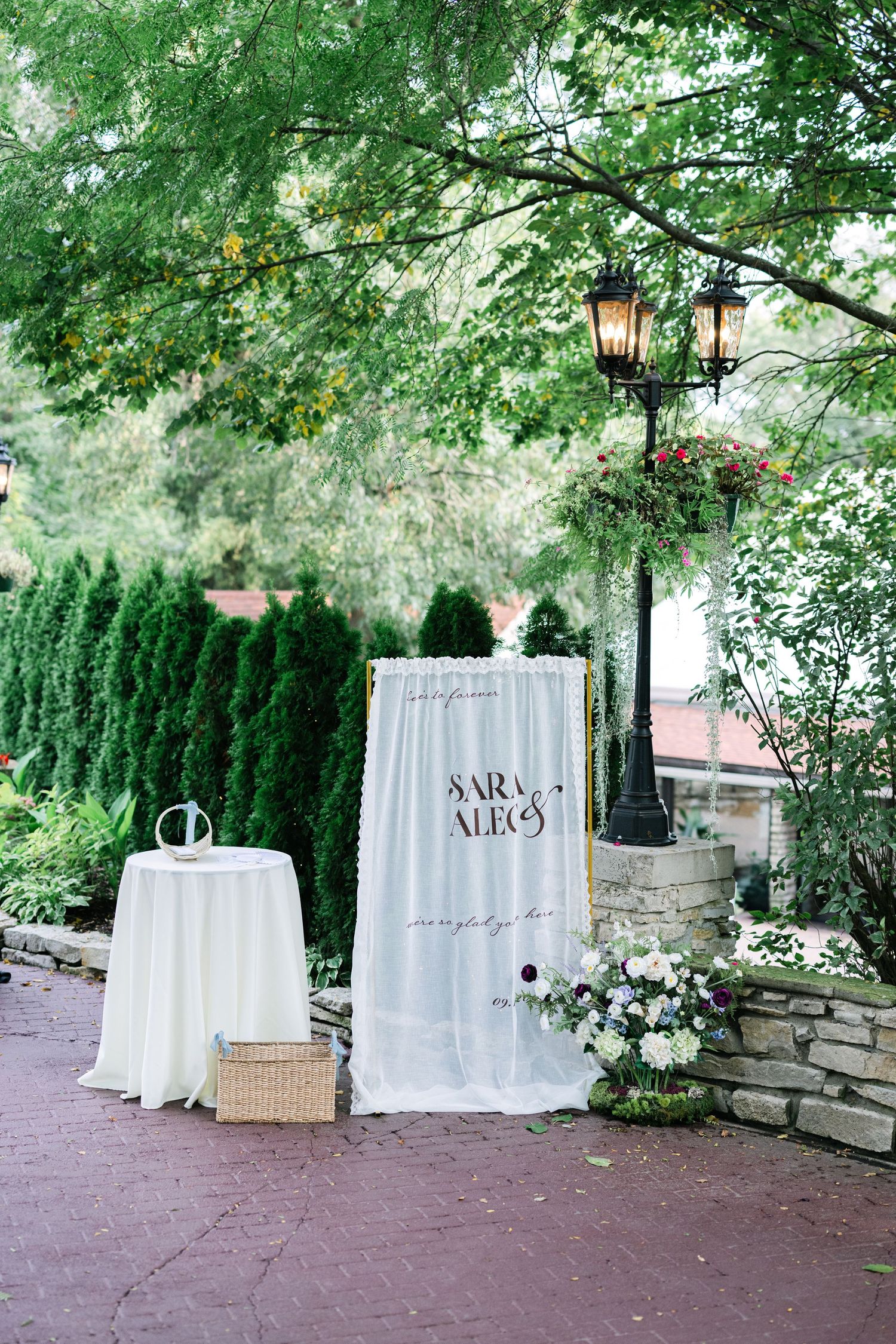 White curtain drapes create an elegant outdoor wedding ceremony backdrop against lush greenery and stone walls. - Meyer's Castle Events