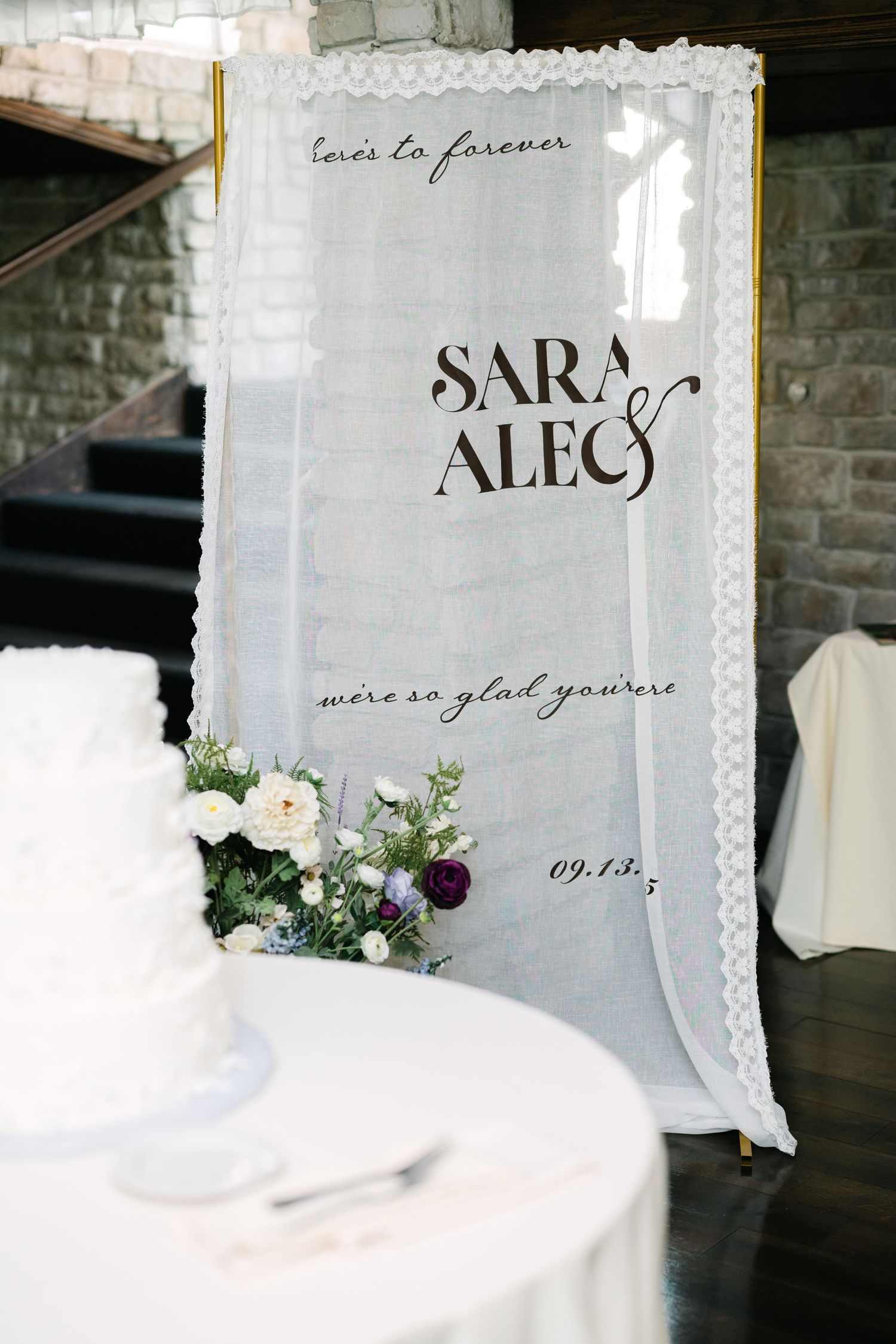 Wedding signage with names and floral decorations in an elegant display. - Meyer's Castle Events