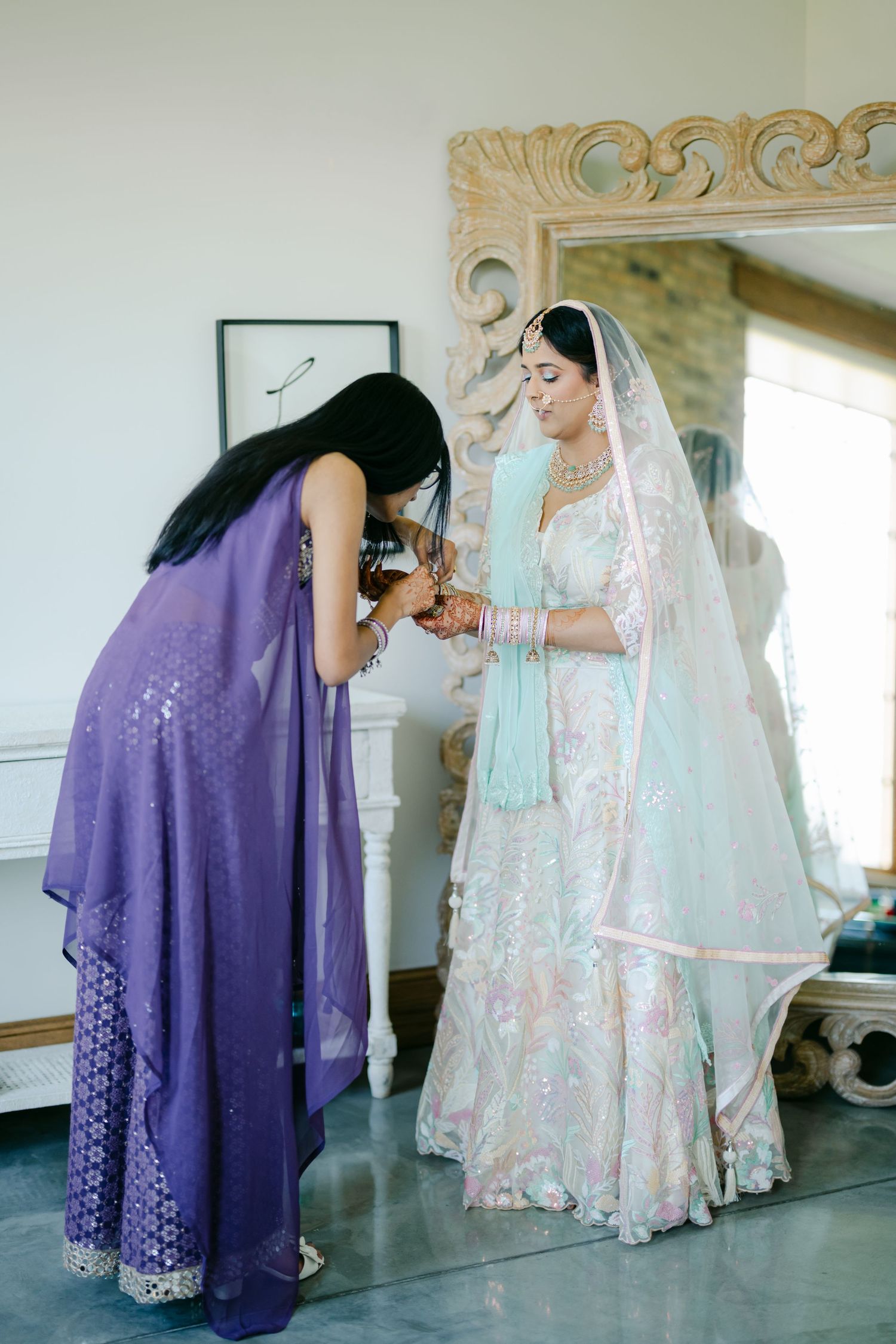 A sequence of images showing someone in a purple dress helping another in a white lace dress and veil get ready. - The Brix on the Fox