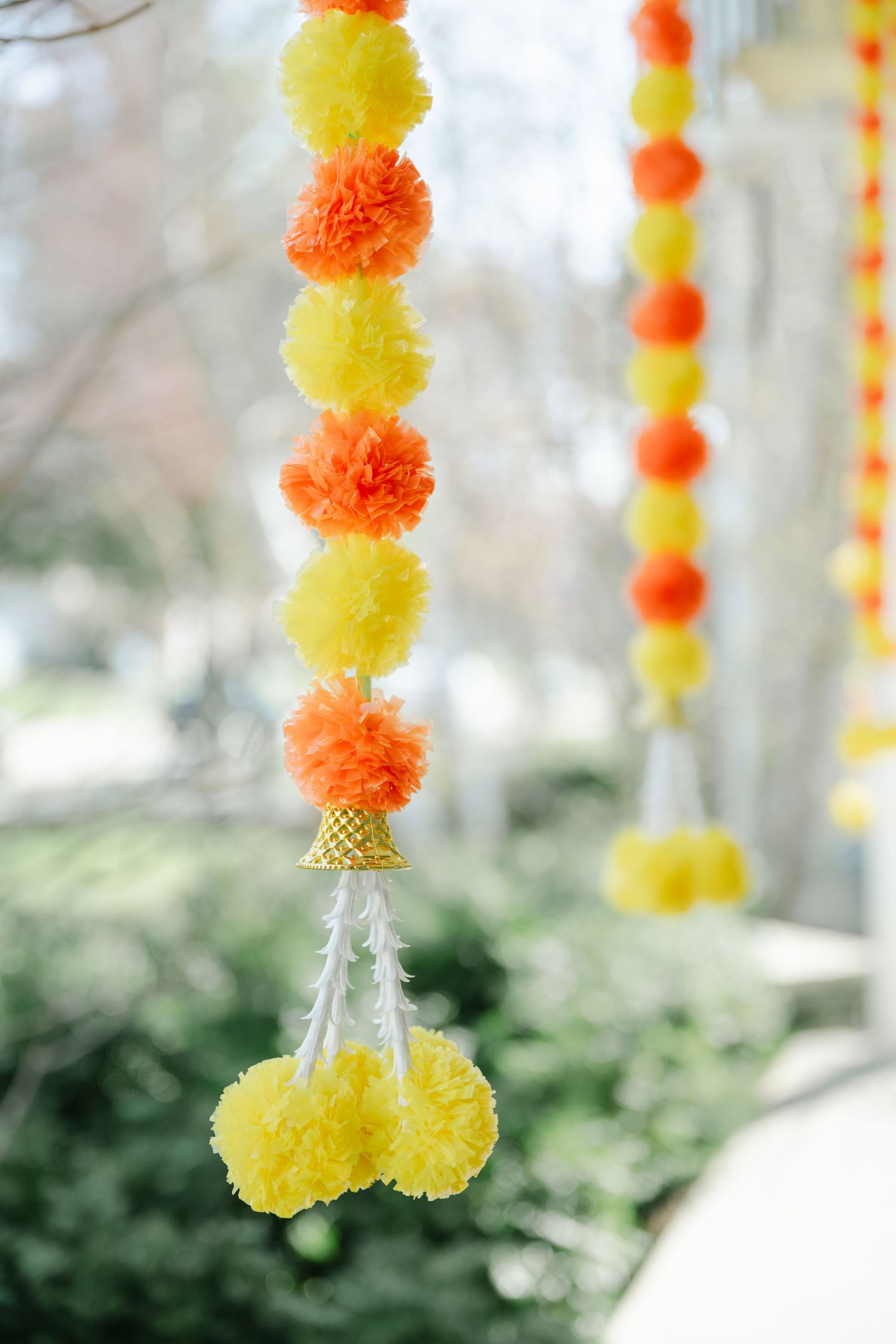 The Brix on the Fox Wedding - Decorative hanging strands of orange and yellow pom pom garlands create a festive party atmosphere.