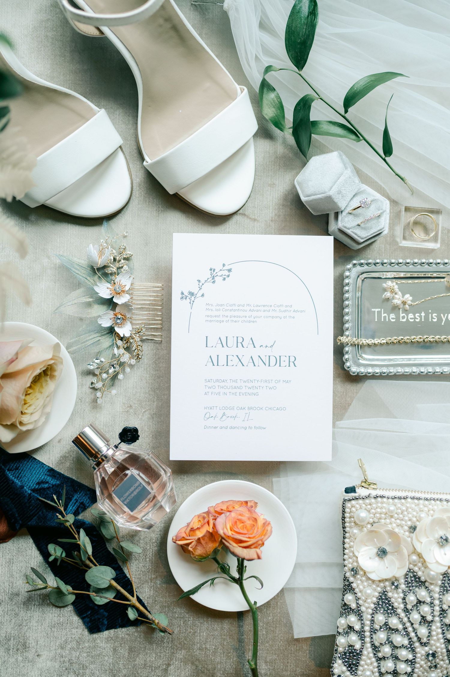 Elegant wedding details including white shoes, invitations, rings, pearls, and coral roses. - Hyatt Lodge Oak Brook