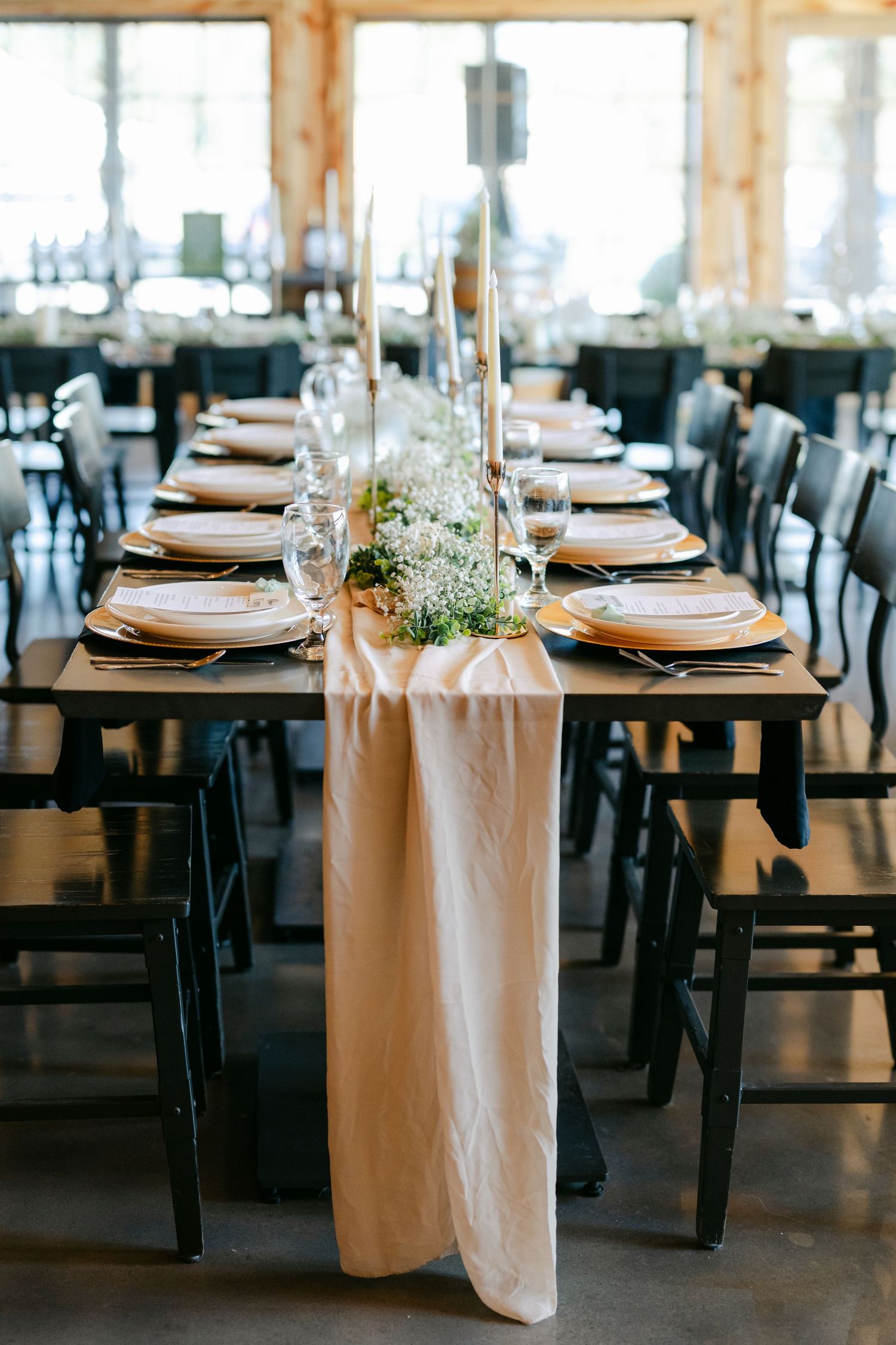 Elegant wedding reception table with blush linen runner, gold chargers, greenery centerpieces. - Youngblood Vineyard Wedding