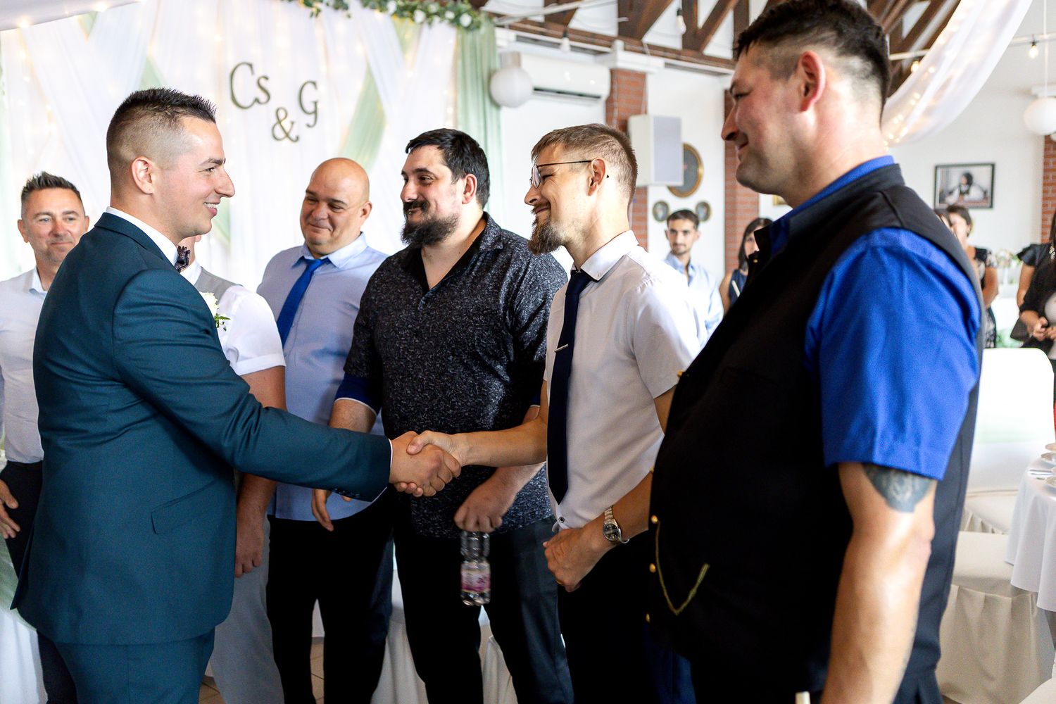 A group of men in business attire stand in conversation at a networking event.