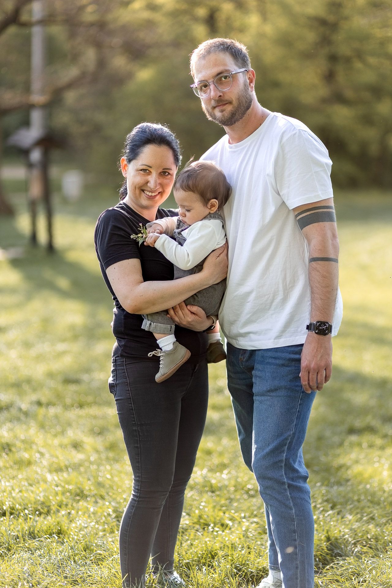 Family sharing joyful moments together in sunny spring park setting.