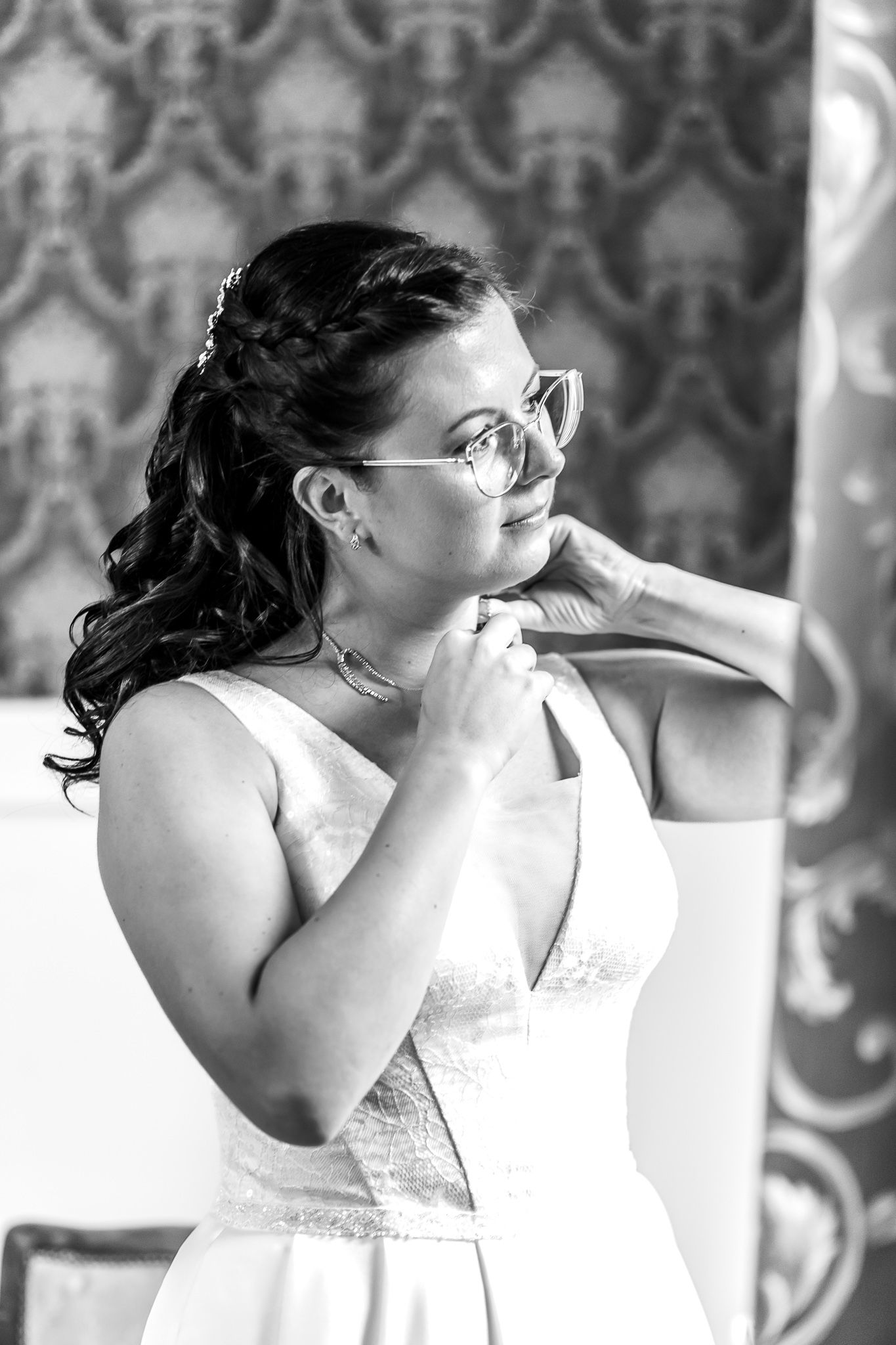A sequence of black and white photos showing someone in a white dress wiping away tears with a tissue.