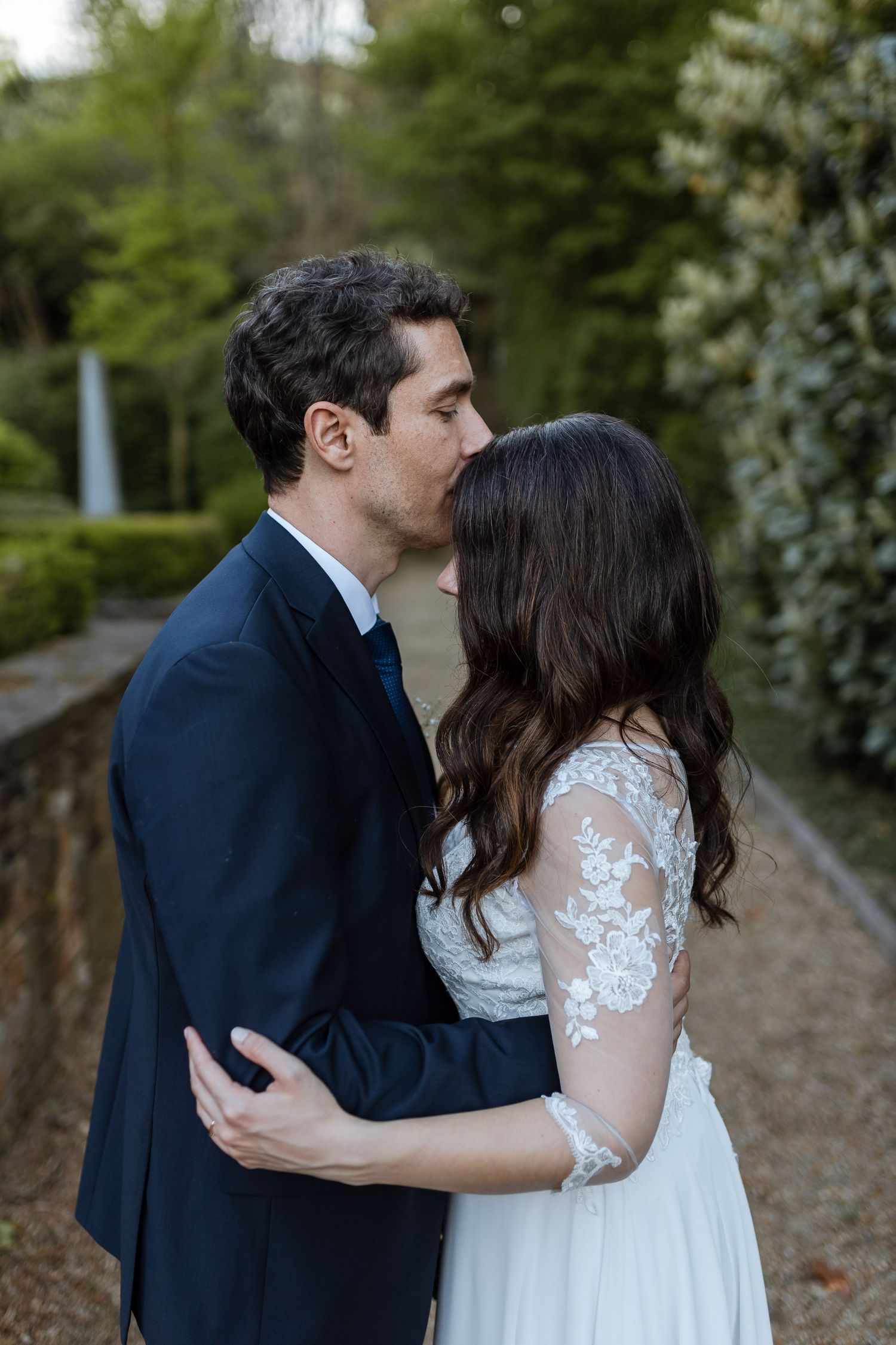 A romantic series of wedding photos showing a couple in a garden setting sharing intimate moments.