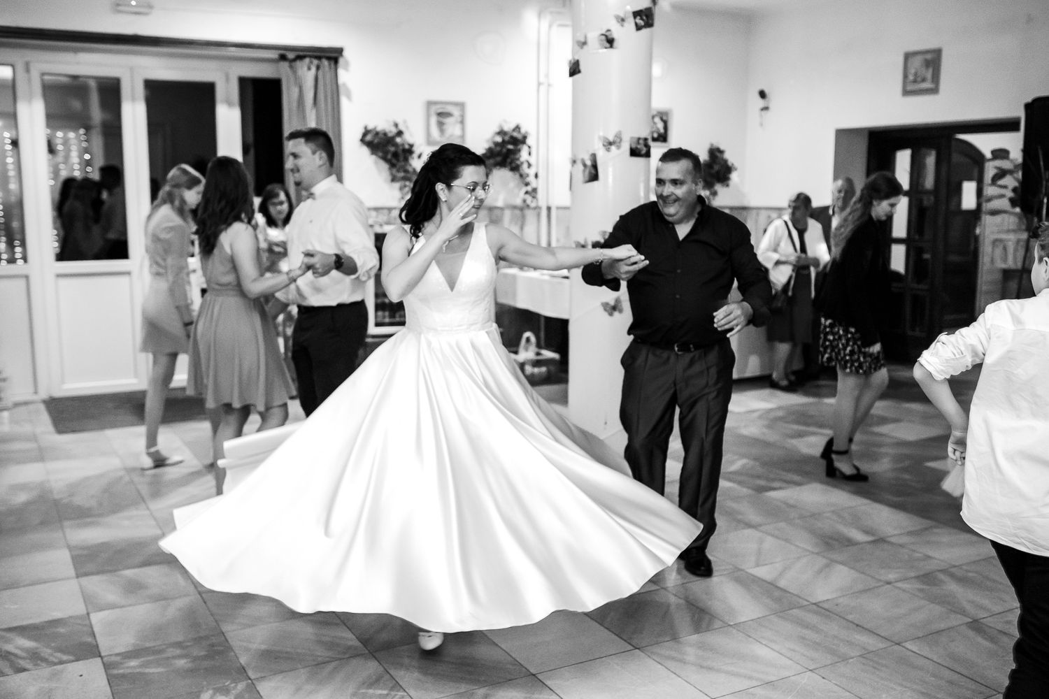 A sequence of black and white photos showing a couple dancing and twirling during a ballroom dance lesson.