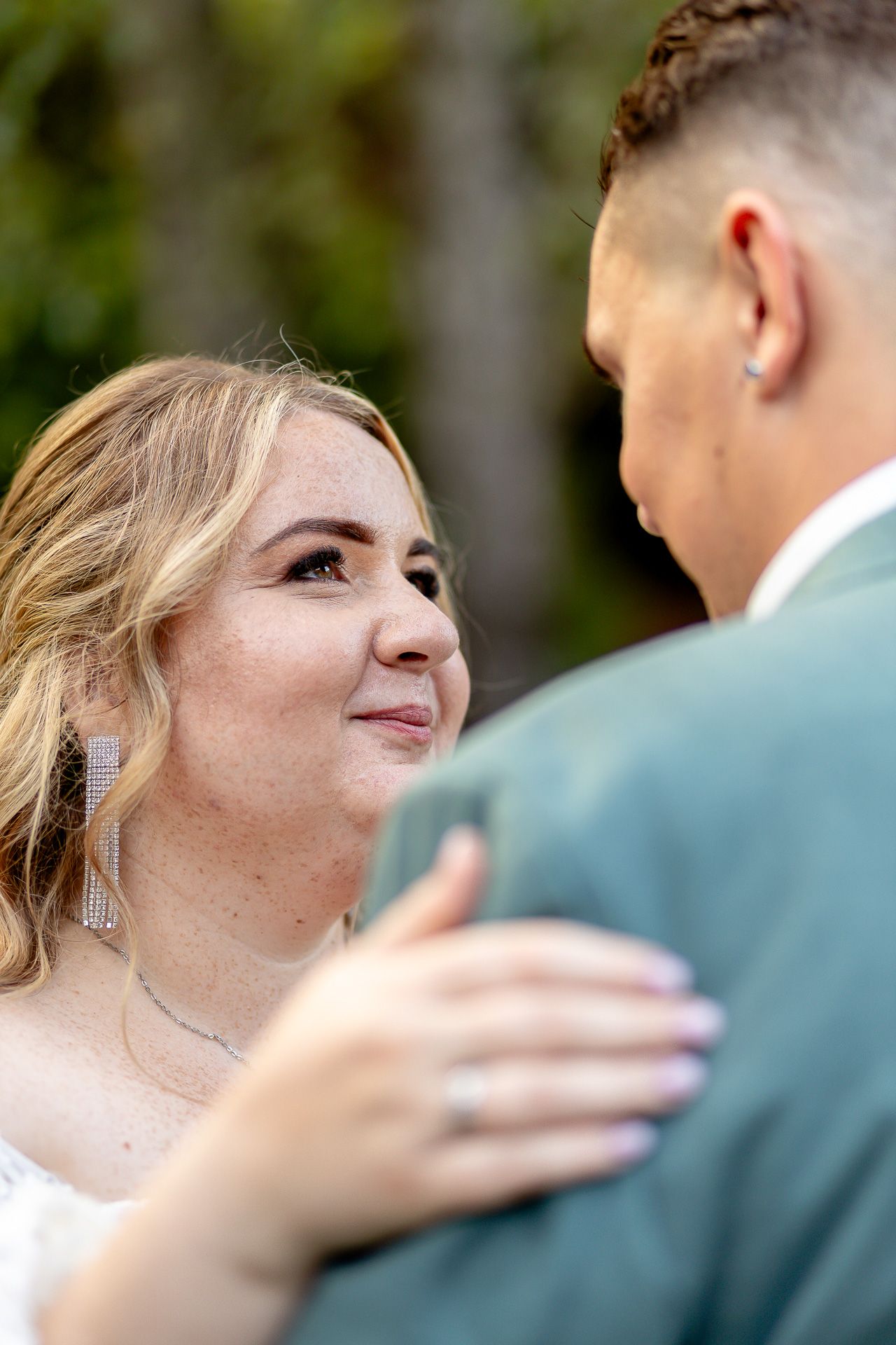A romantic wedding moment captured in a sequence showing the couple gazing at each other during their outdoor ceremony.