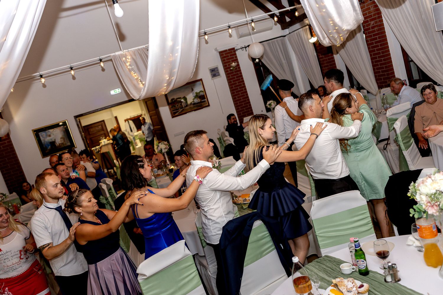 A sequence of dance party photos showing people celebrating and dancing together in an indoor venue.