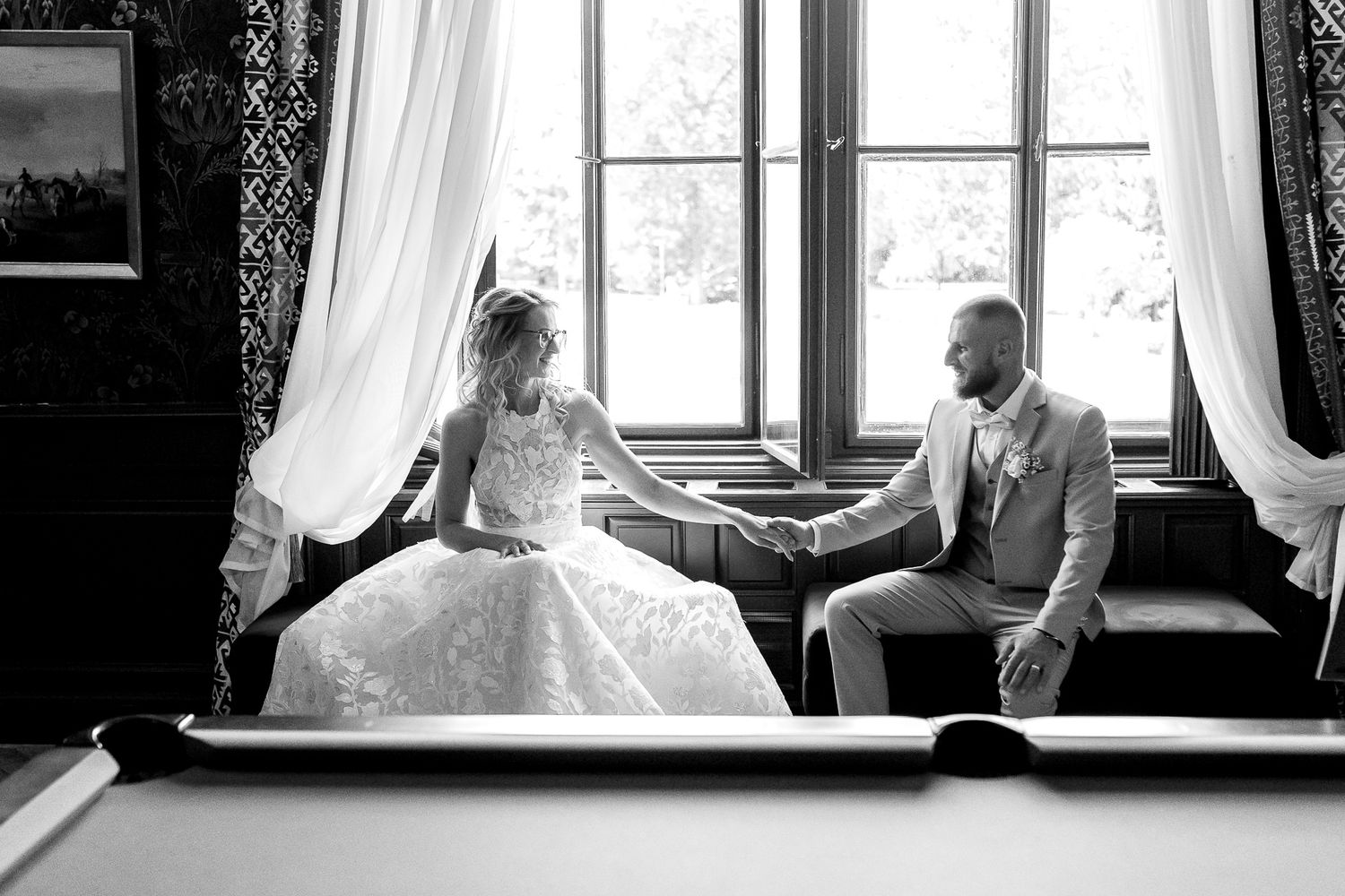 Black and white wedding photos showing intimate moments between couples in vintage-style window settings.