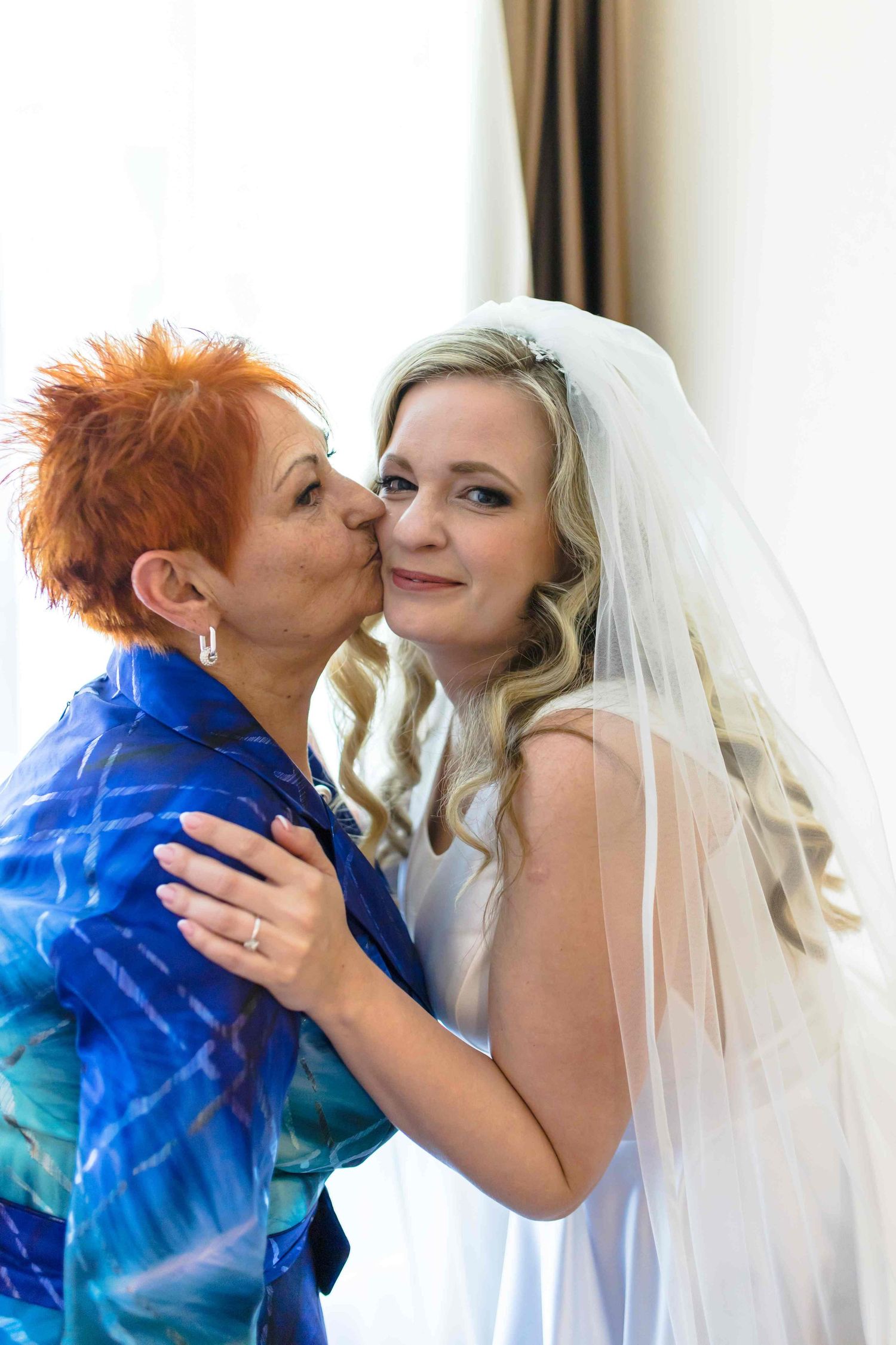 A tender moment captured in a series of four wedding photos showing a couple sharing sweet kisses.