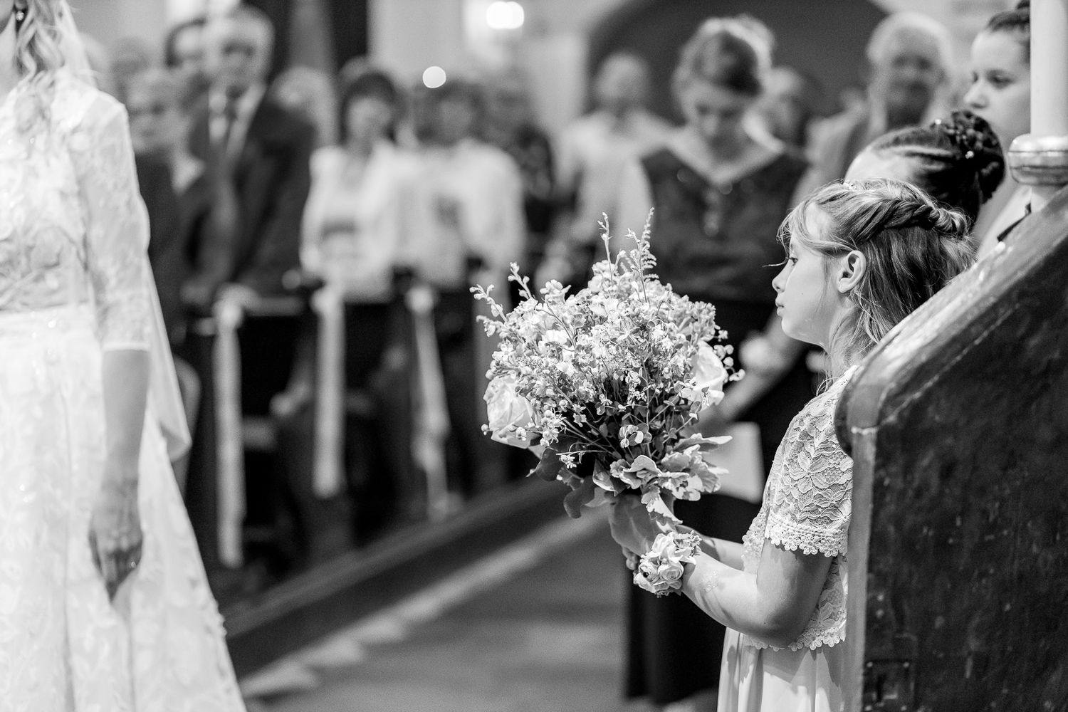 A wedding couple shares an intimate moment during their first dance at an indoor reception venue.