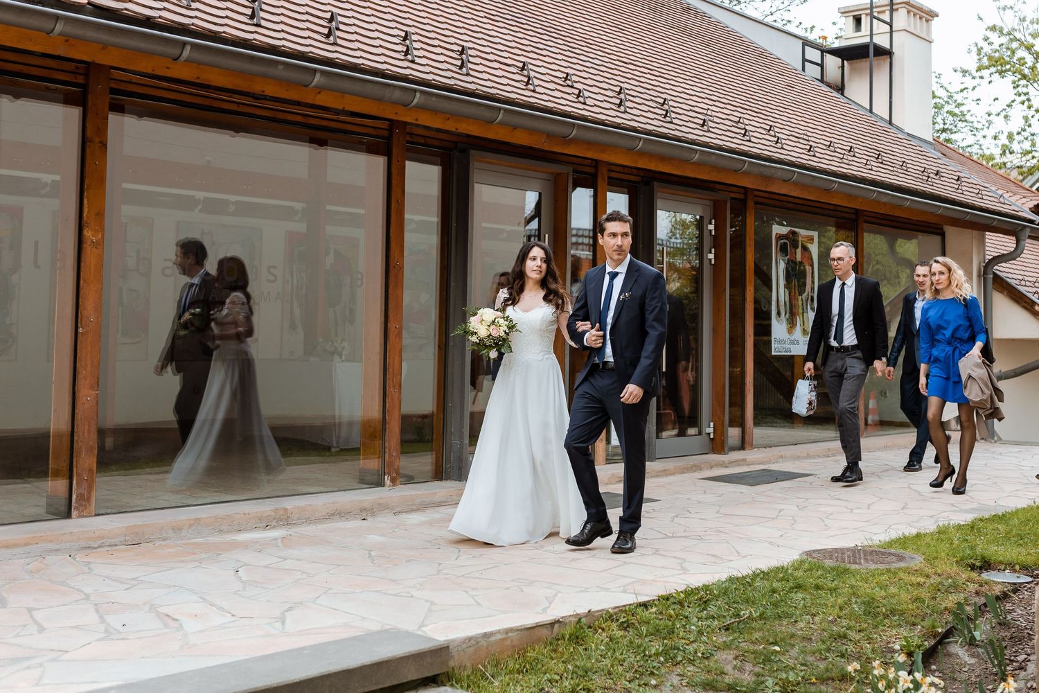 A sequence of wedding photos showing a couple walking along a covered outdoor walkway at different angles.