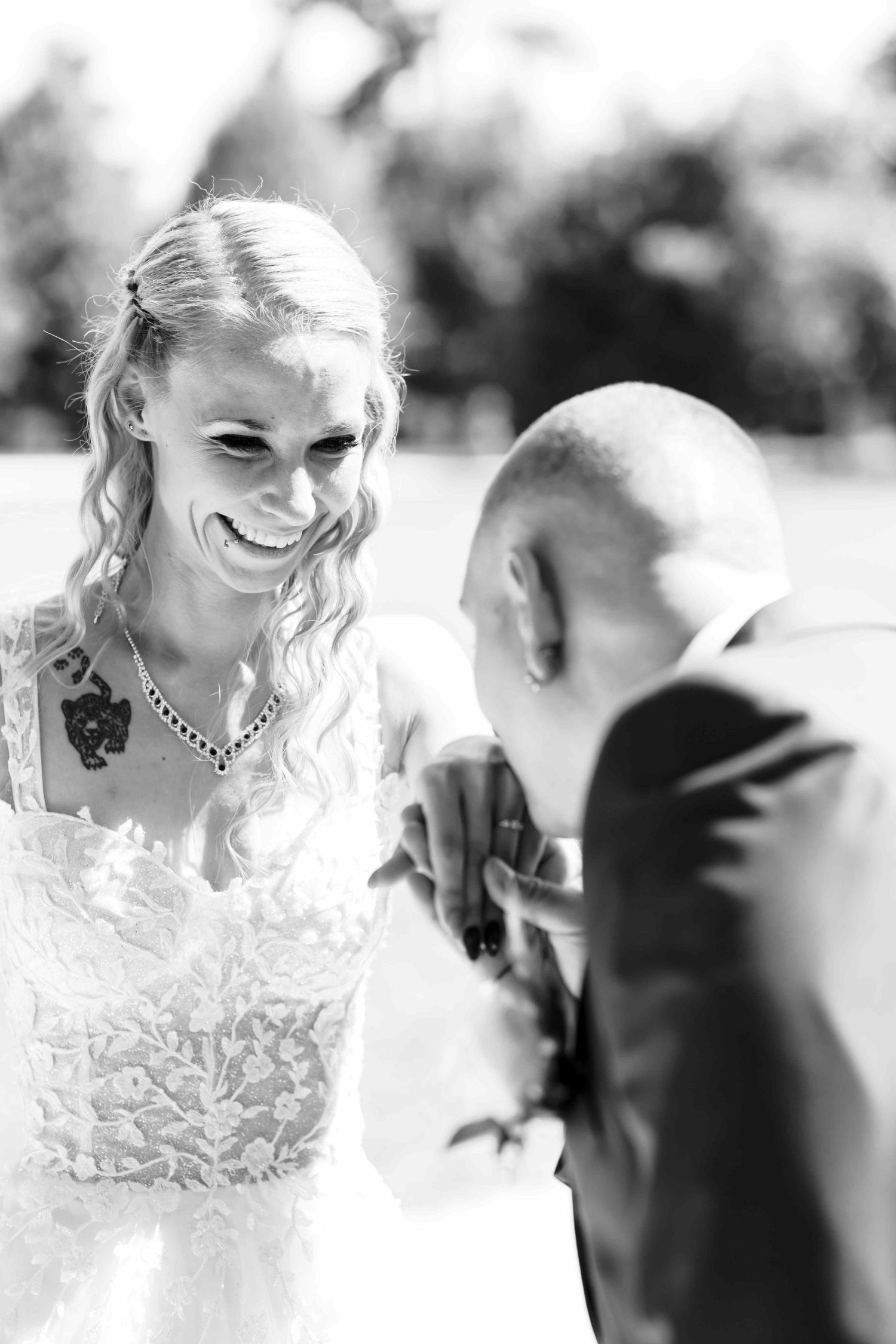 Black and white wedding portrait captures genuine laughter and joy between the couple.