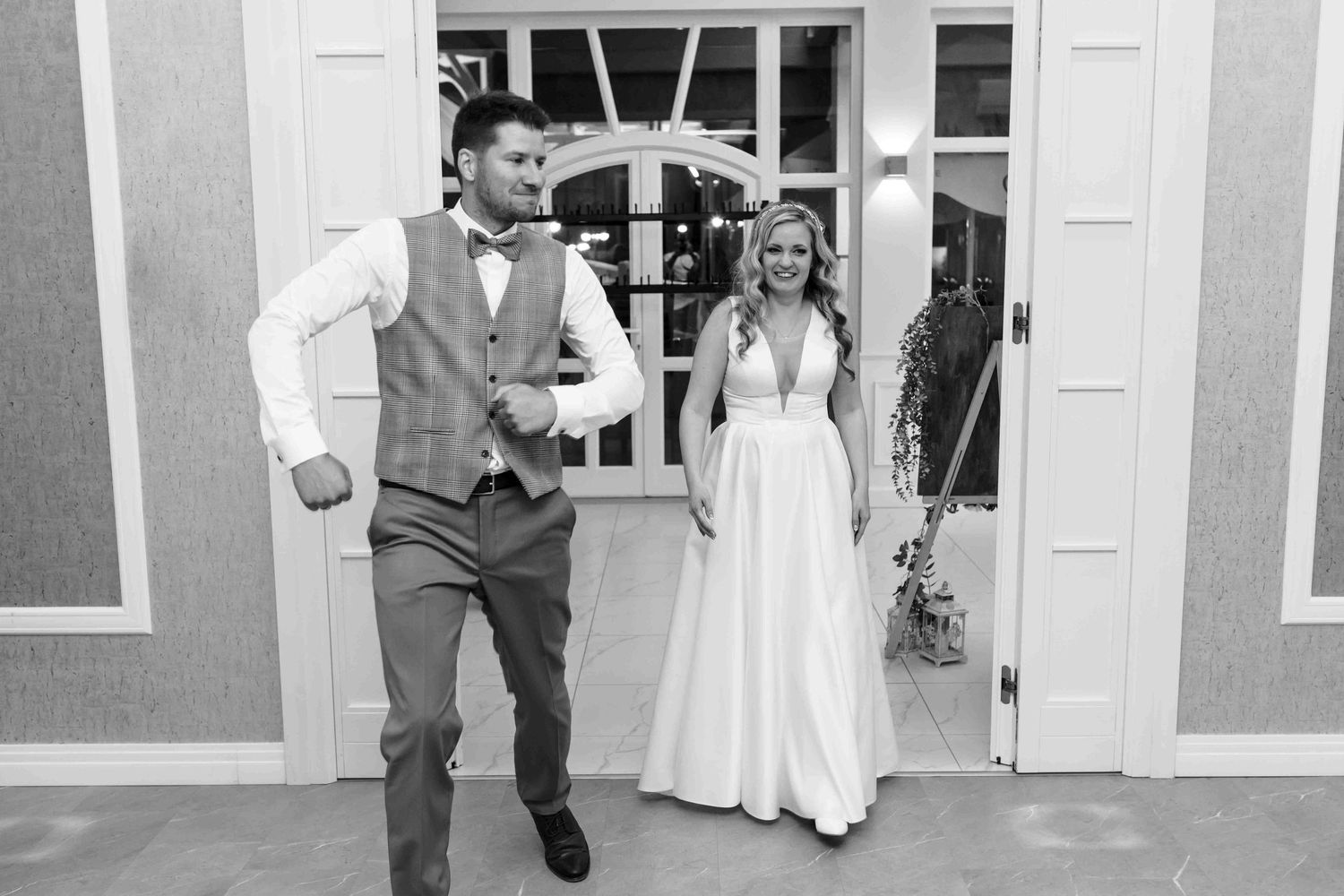 A series of black and white wedding photos showing couples dancing and walking together at an outdoor venue.