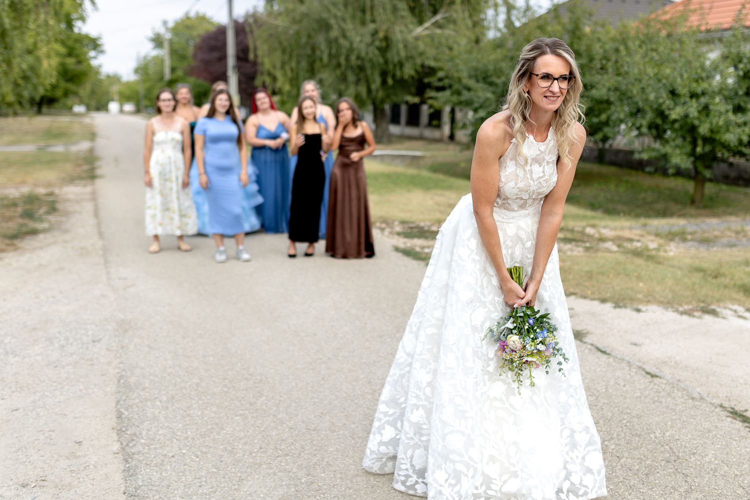 A collection of outdoor wedding photos showing people in white dresses walking through a garden setting.