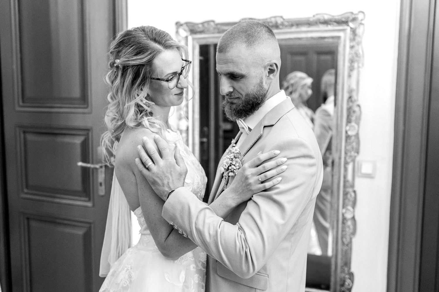 A black and white photo collage showing three romantic moments of a couple embracing and dancing together.