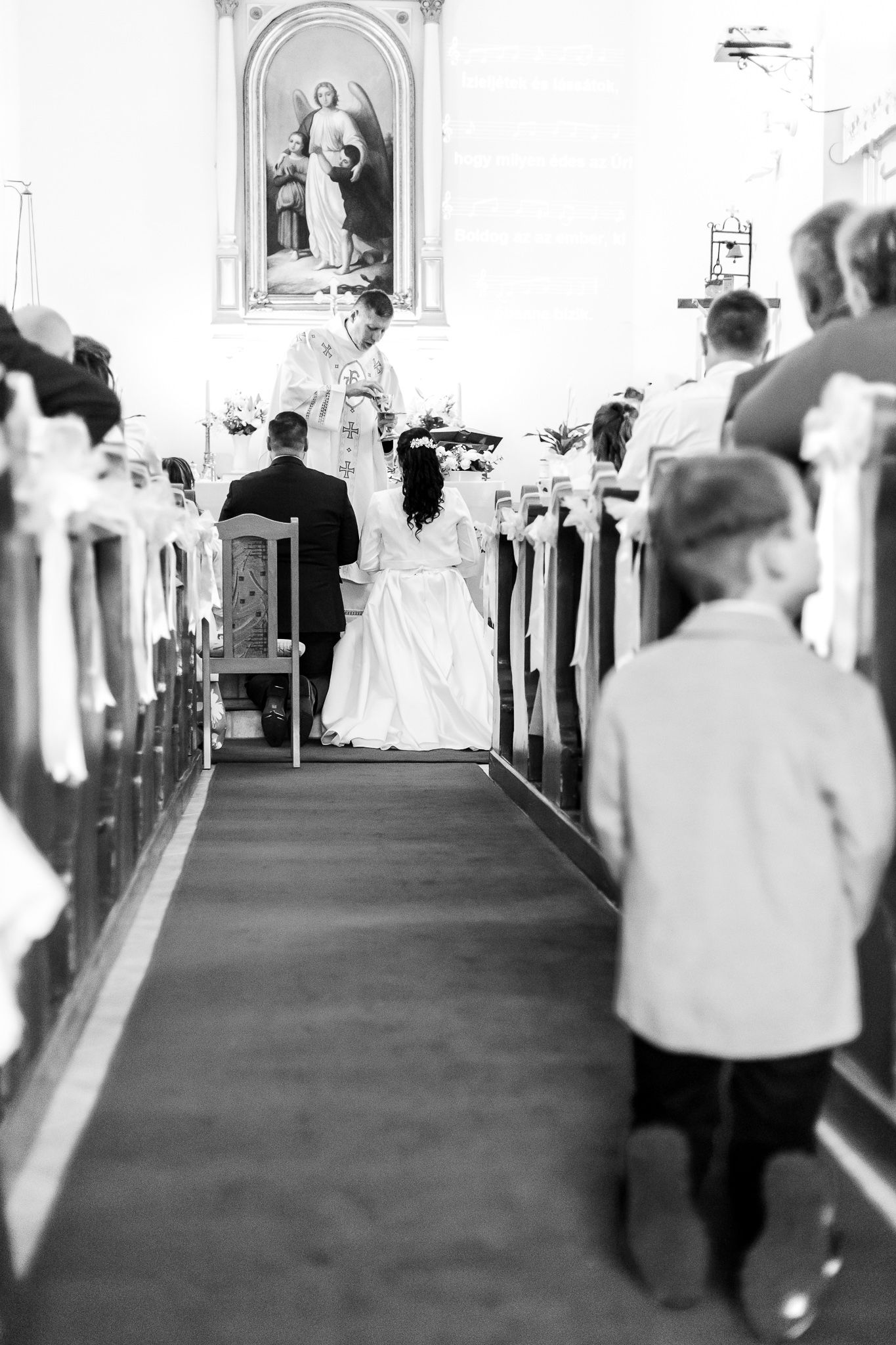 Black and white photos showing church pews and aisle during a religious ceremony.