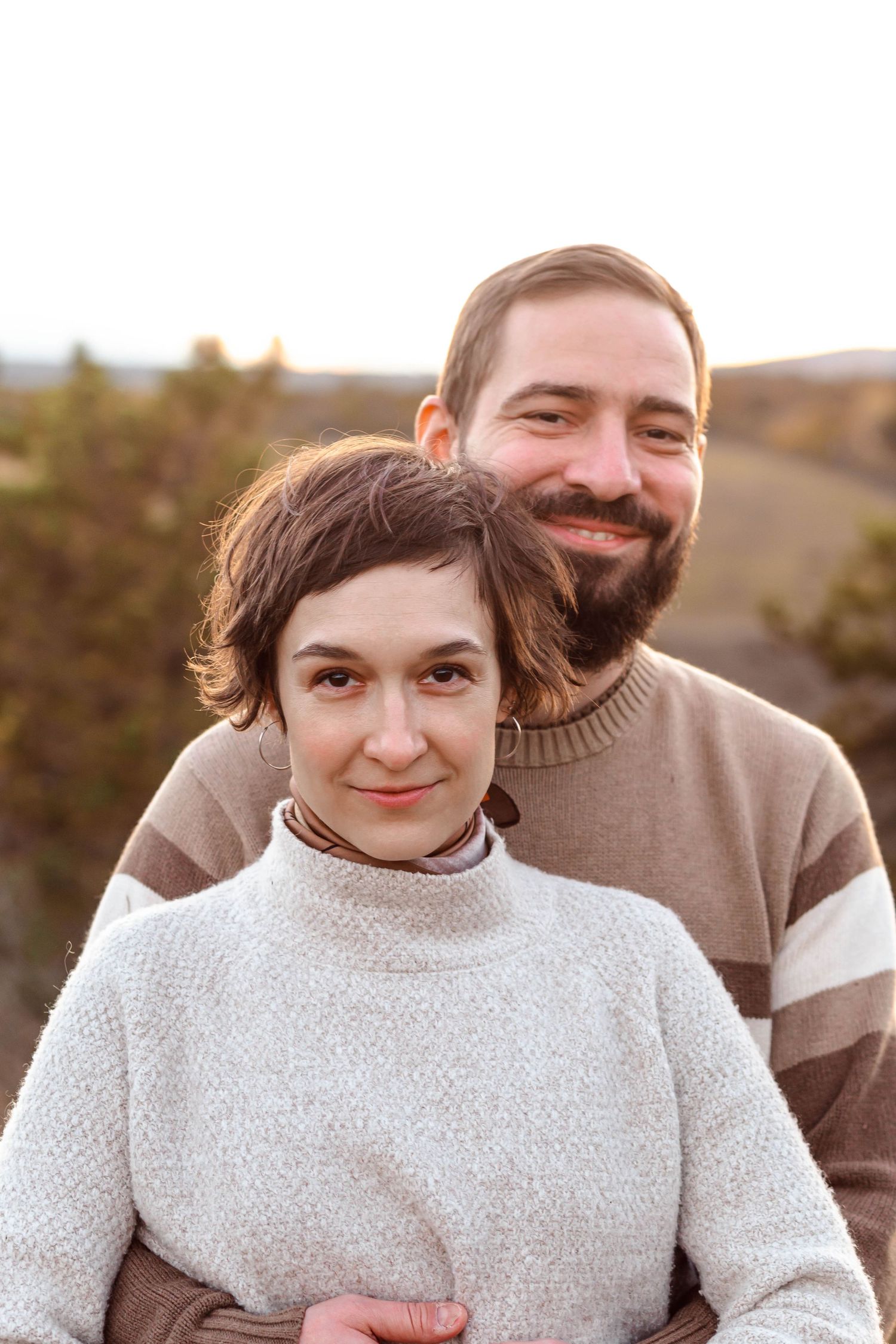 Casual outdoor family portrait with natural smiles during golden hour.