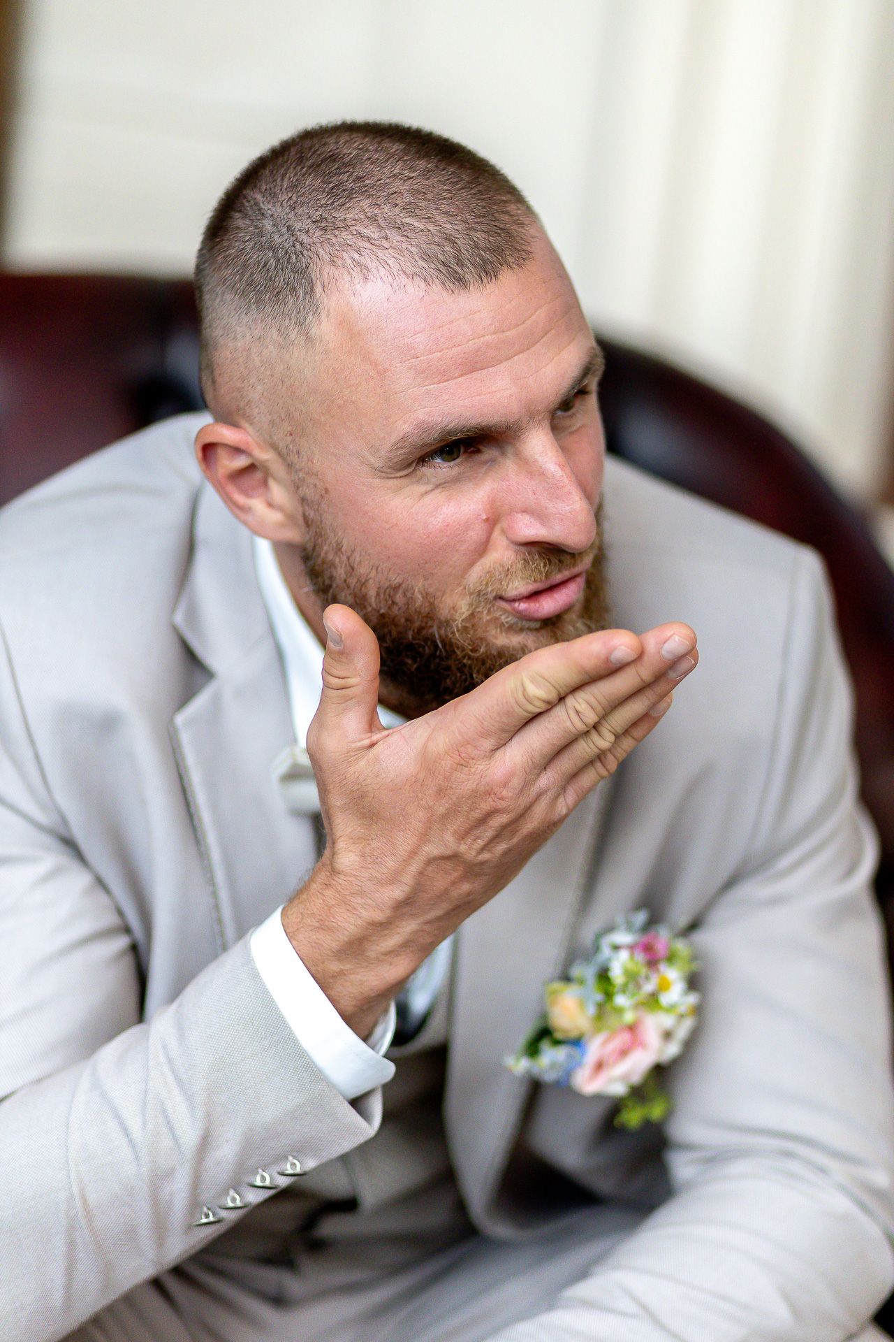 A groom in a light gray suit shows emotional reactions in a series of candid wedding photos.
