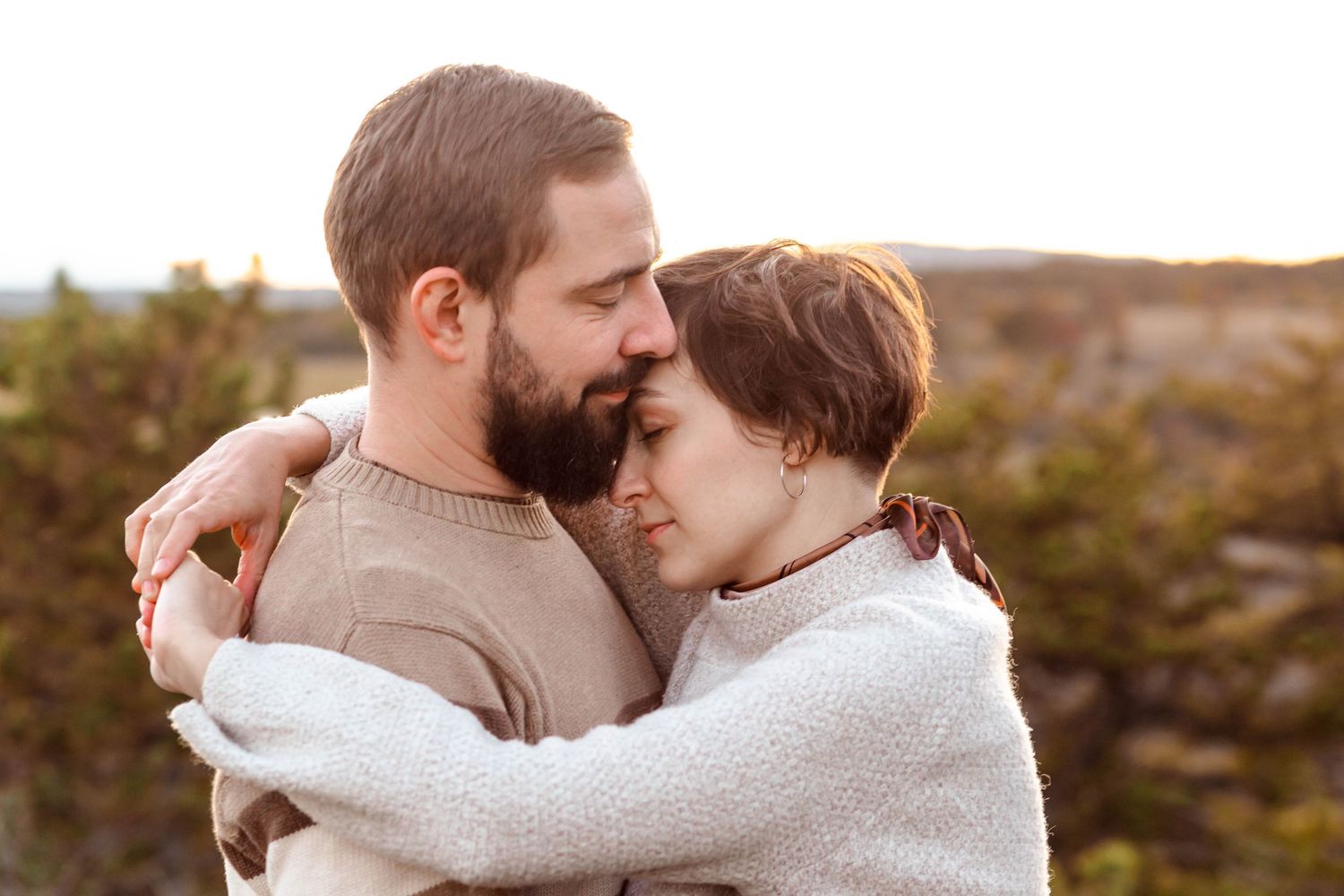 Intimate family embrace captured during golden hour photography session.