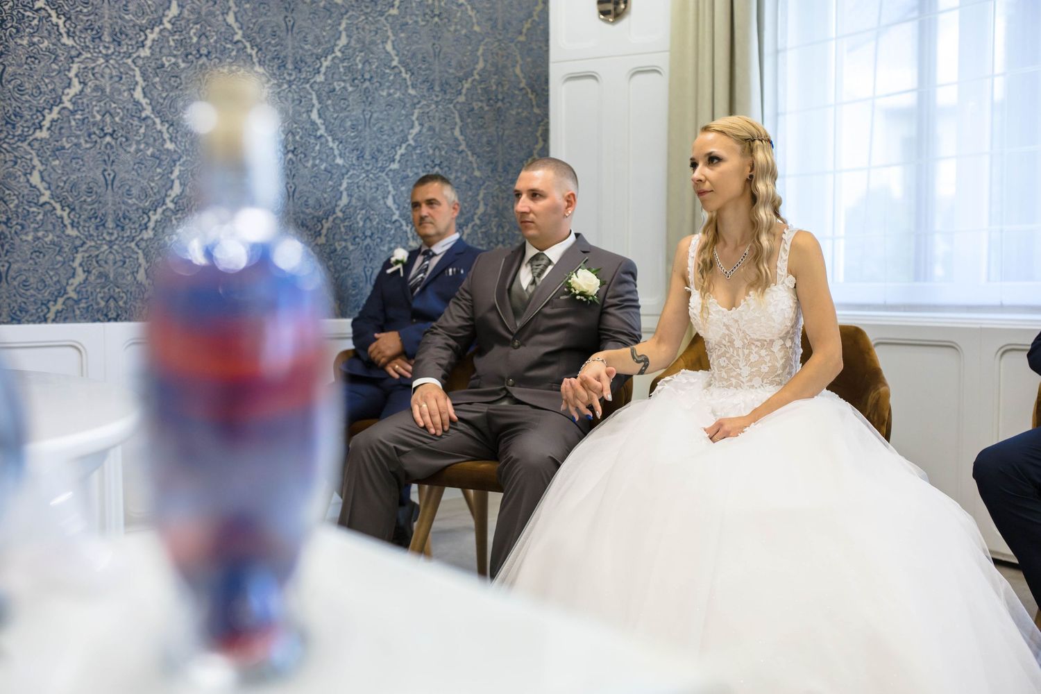 A series of photos showing people sitting in a bridal boutique with elegant decor and white dresses.