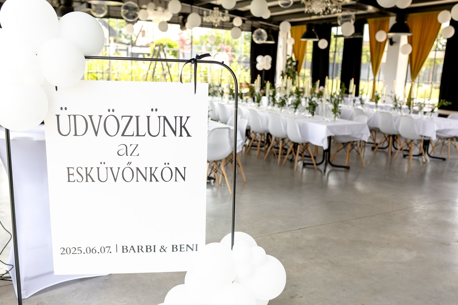Modern event venue interior with white chairs set up for a celebration.