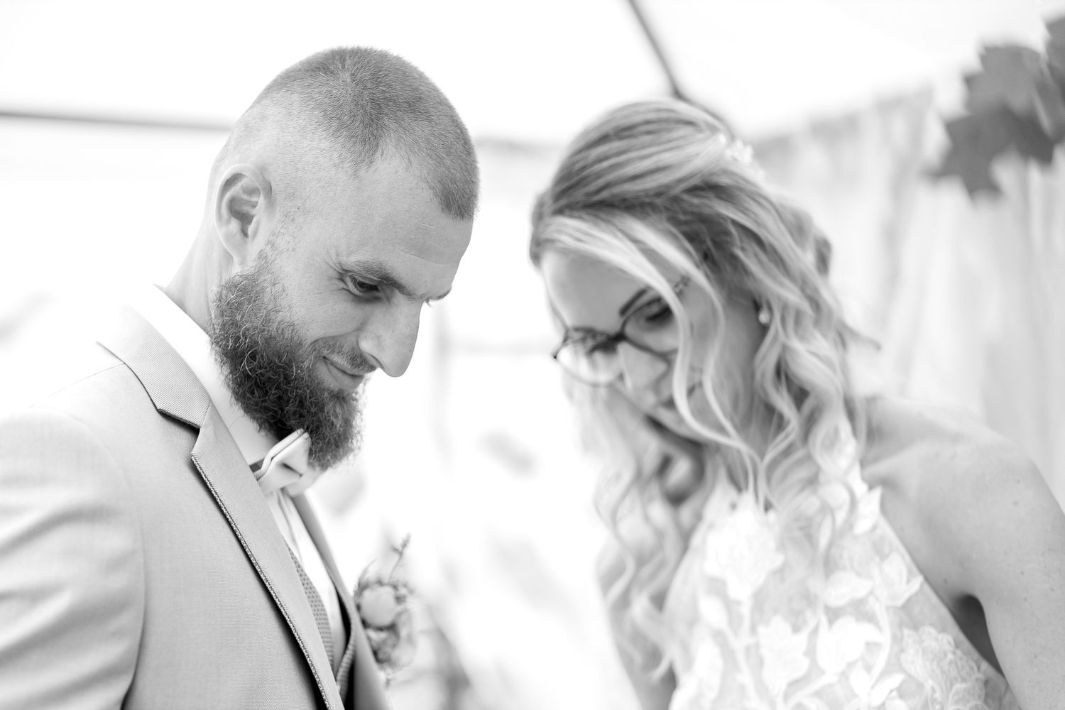 A black and white photo series shows tender moments between a couple on their wedding day.