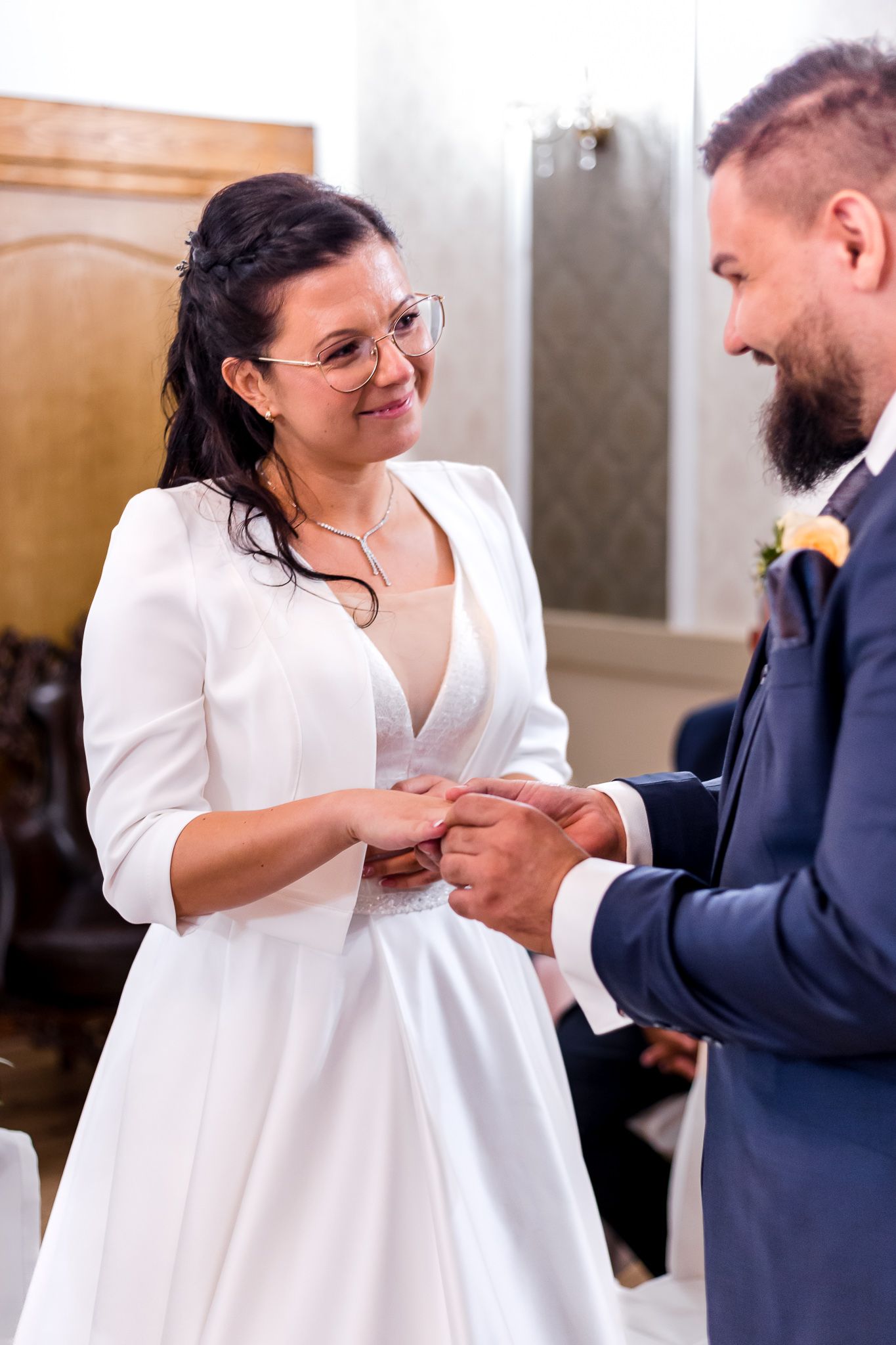 A couple shares a tender moment during their wedding ceremony as they exchange rings and vows.