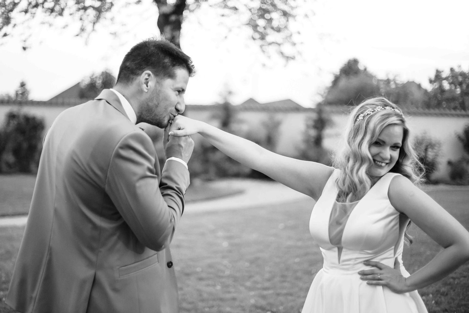 A series of romantic black and white wedding photos showing tender moments between a couple in an outdoor setting.