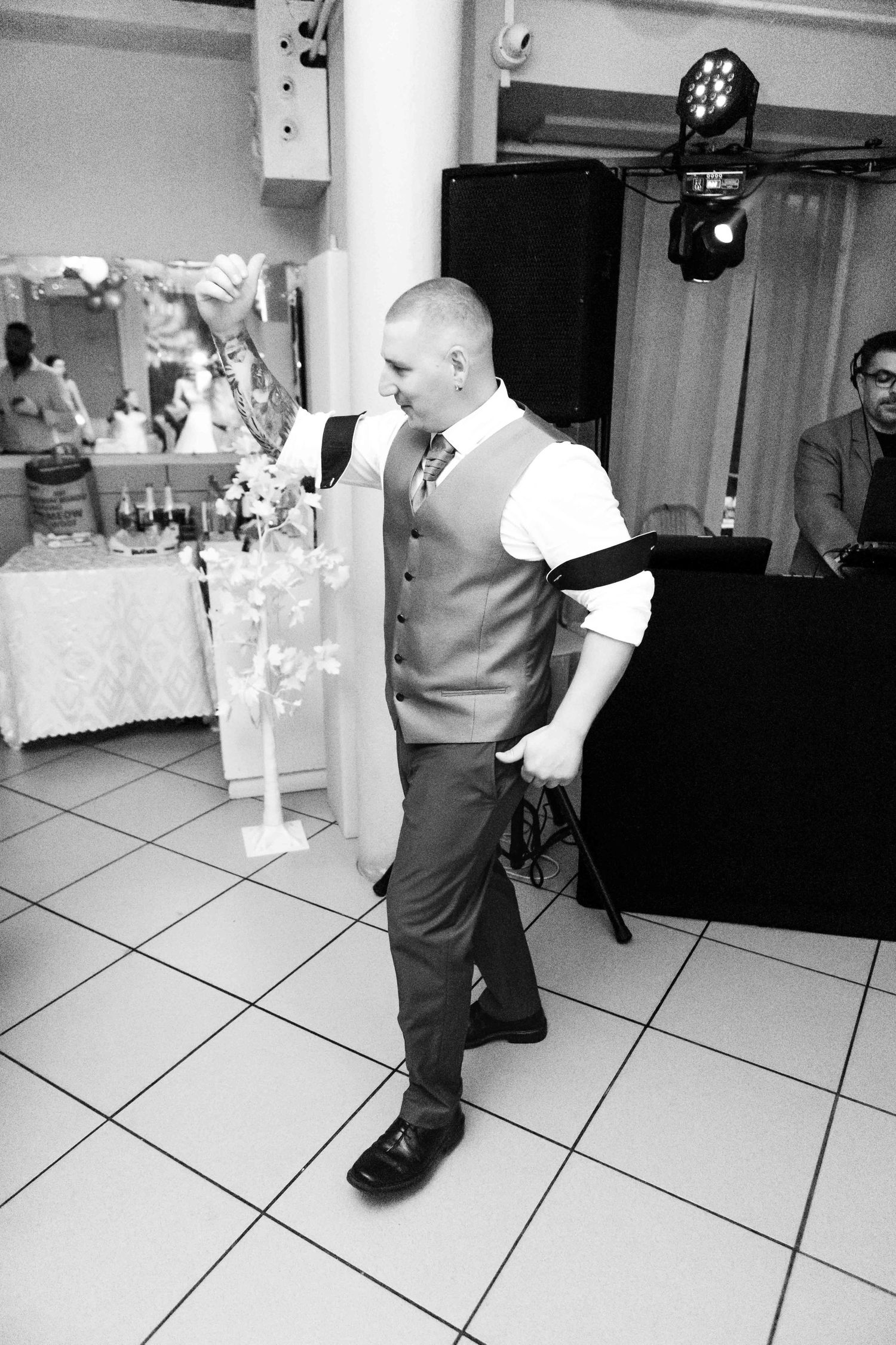 A sequence of black and white photos showing a couple dancing at a wedding reception on a tiled floor.