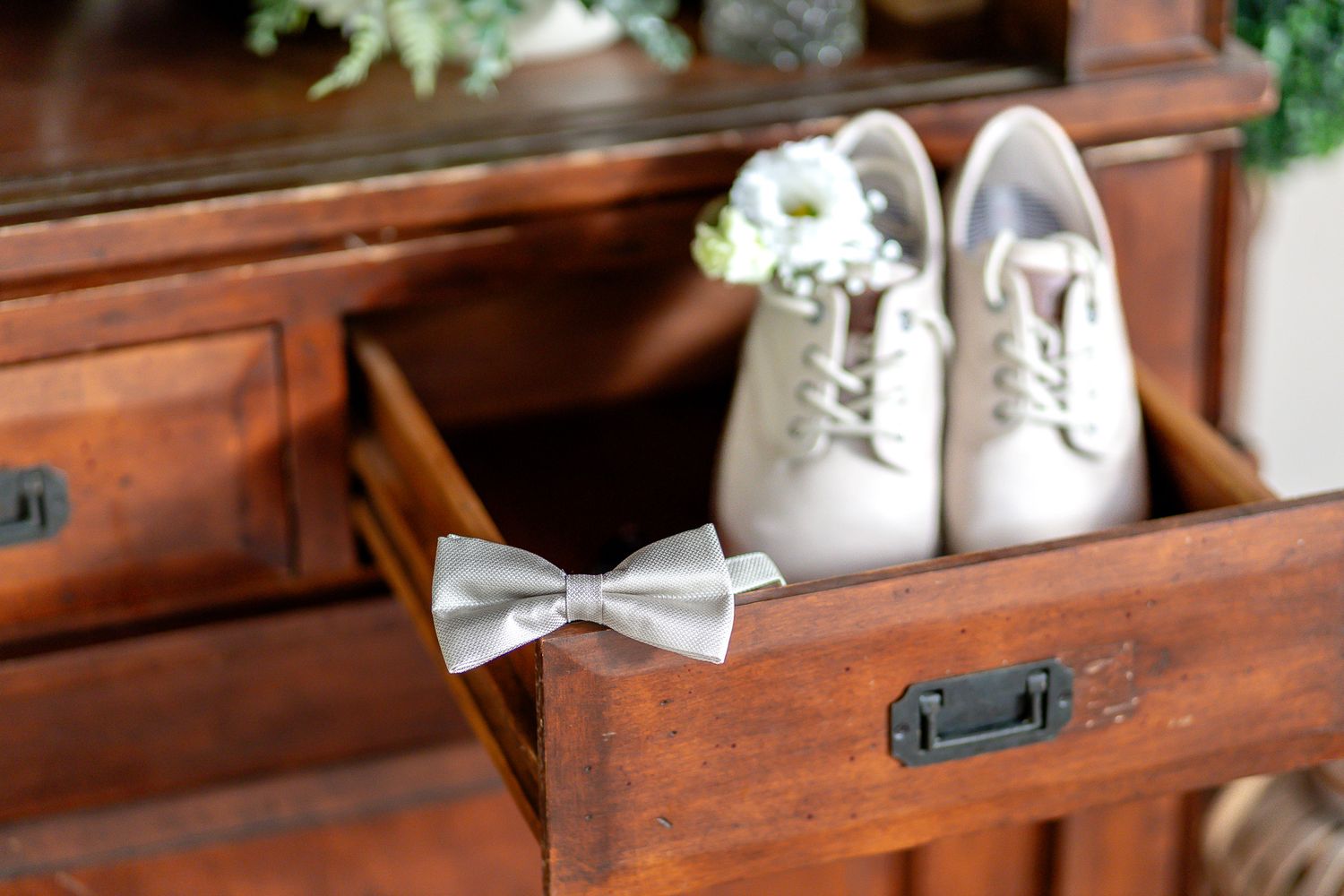White sneakers with brown paper bags are arranged on wooden shelves for storage and organization.